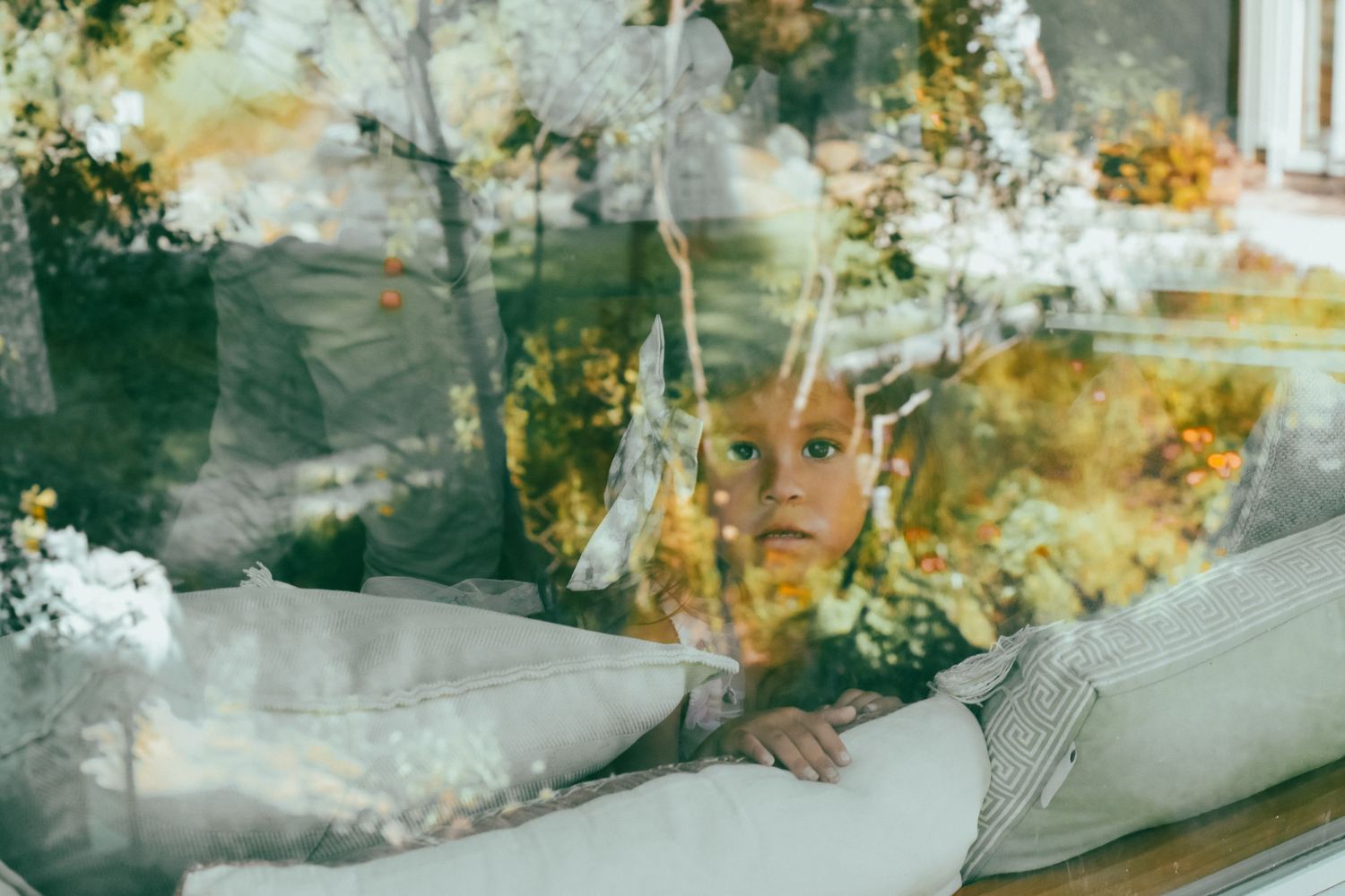a child in a window watching a wedding