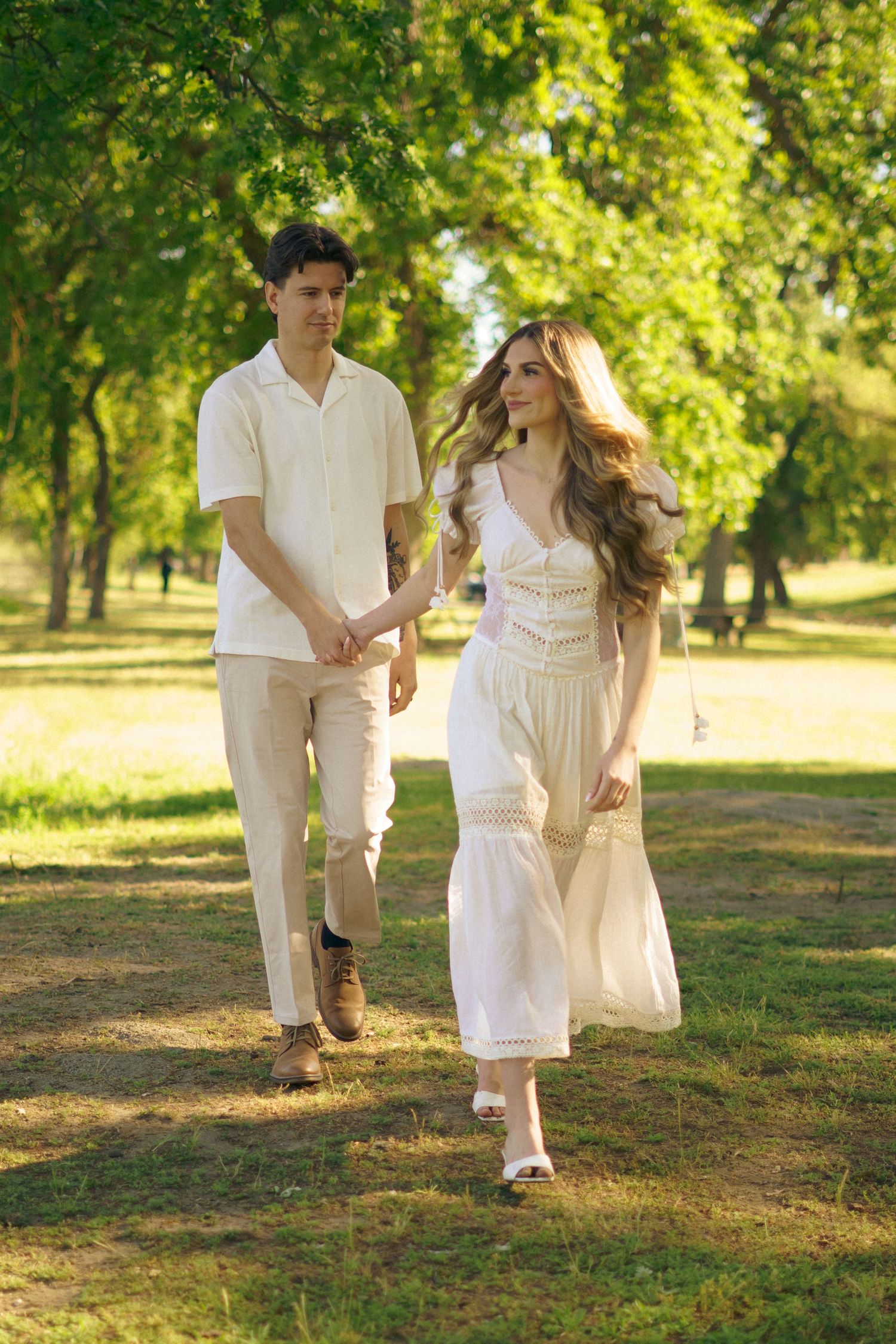 An engaged couple walk in Fresno Ca - It is a vintage styled whimsical shoot