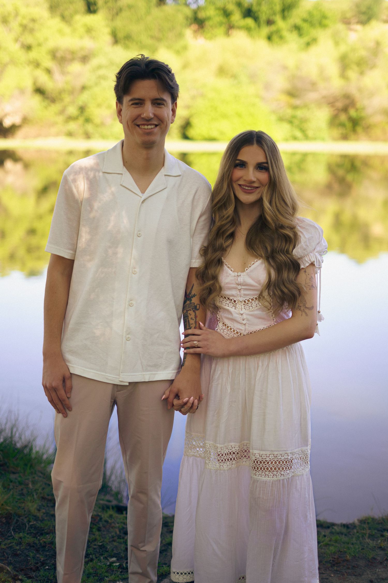 An engaged couple stand together