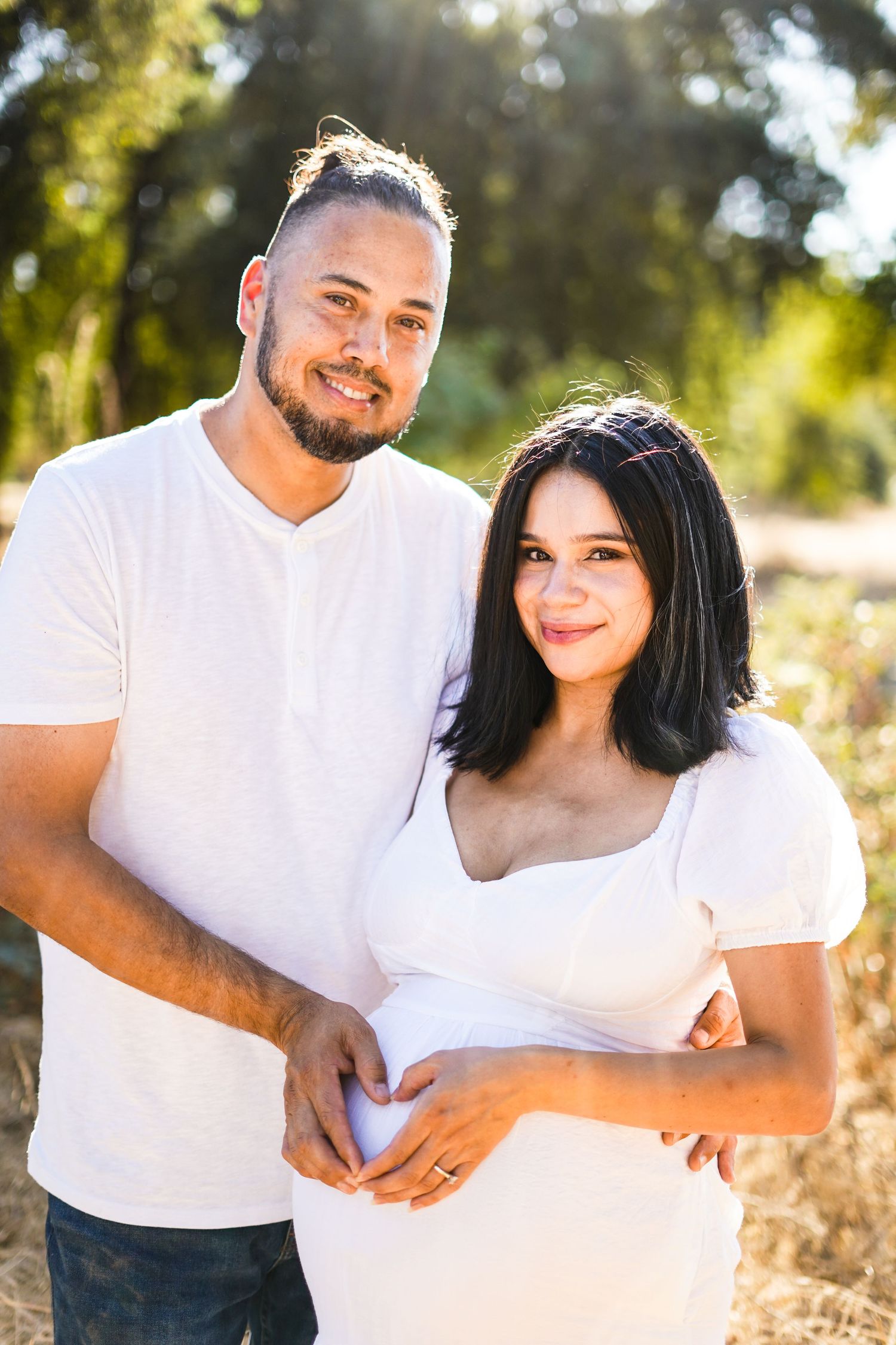 Maternity picture of woman and husband in Exeter field cinematic