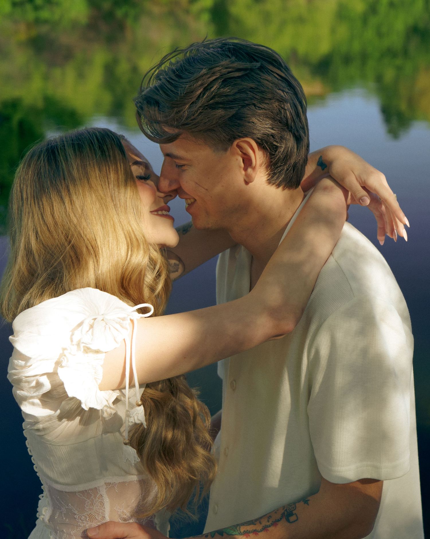 An engaged couple kiss