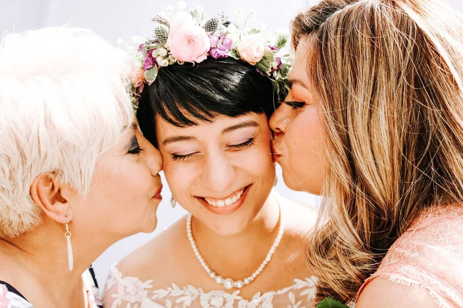 Tulare wedding bride is kissed by mother and grandma