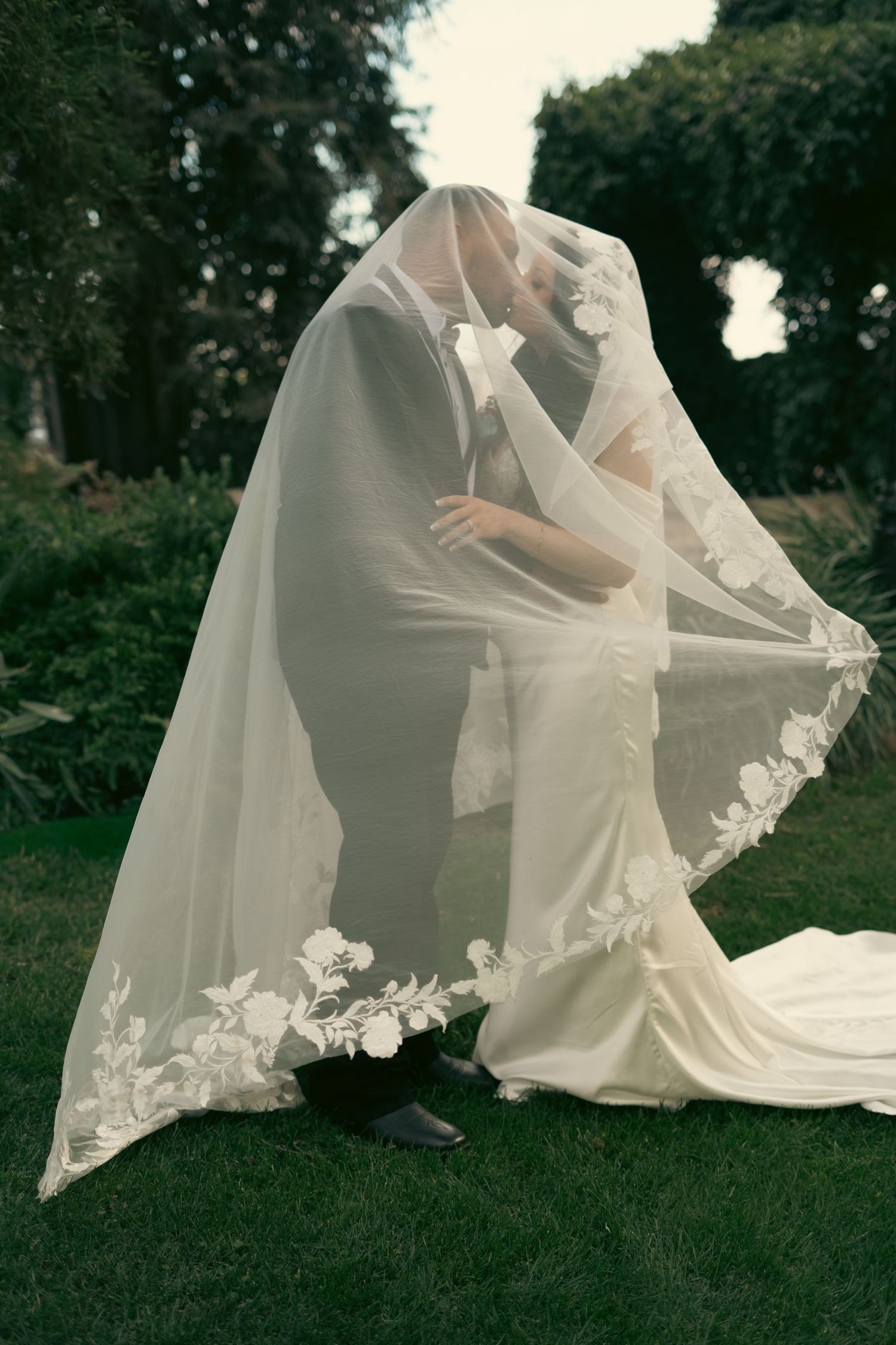 M Ranch Bride and Groom Kissing under veil in Tulare