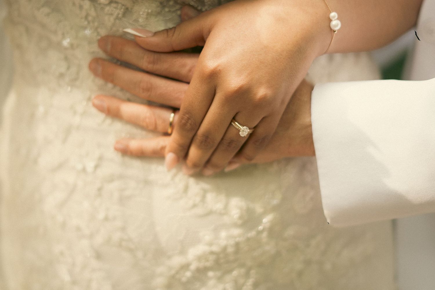 Visalia California Couple holds hands with ring showing. Photo has a cinematic overlay
