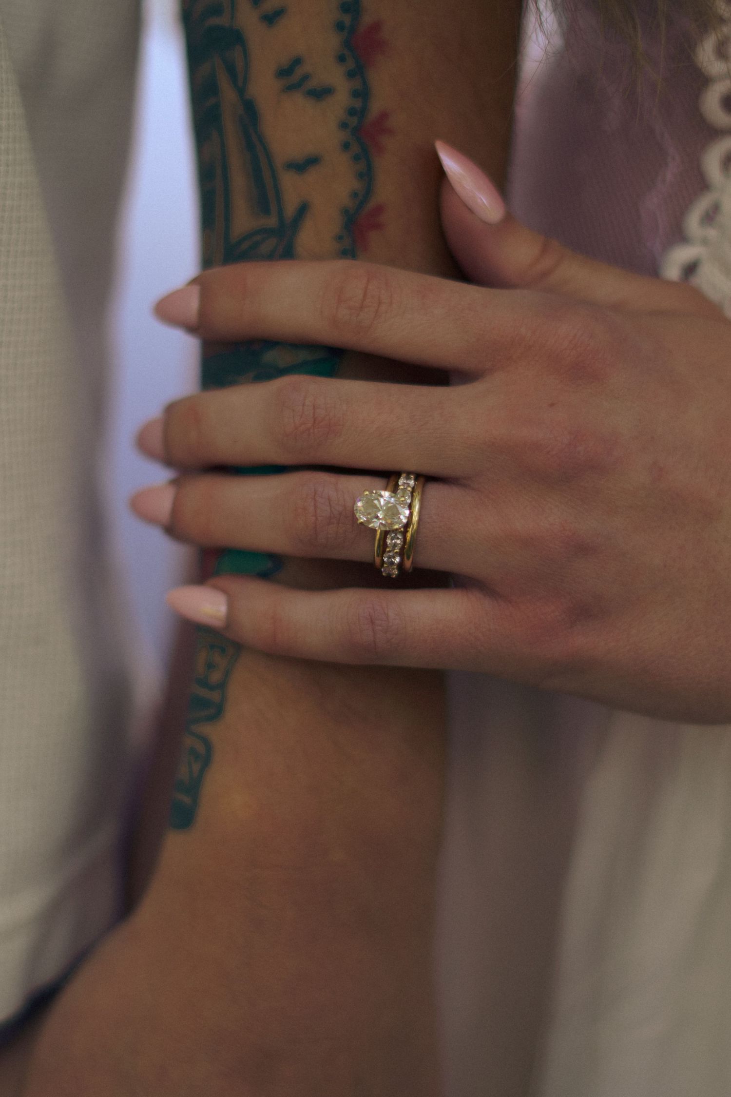 An engaged couple show rings