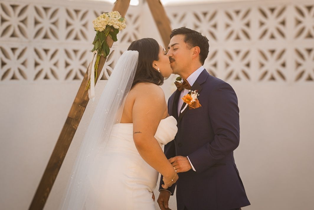 Couple in Visalia Ca hold hands and kiss