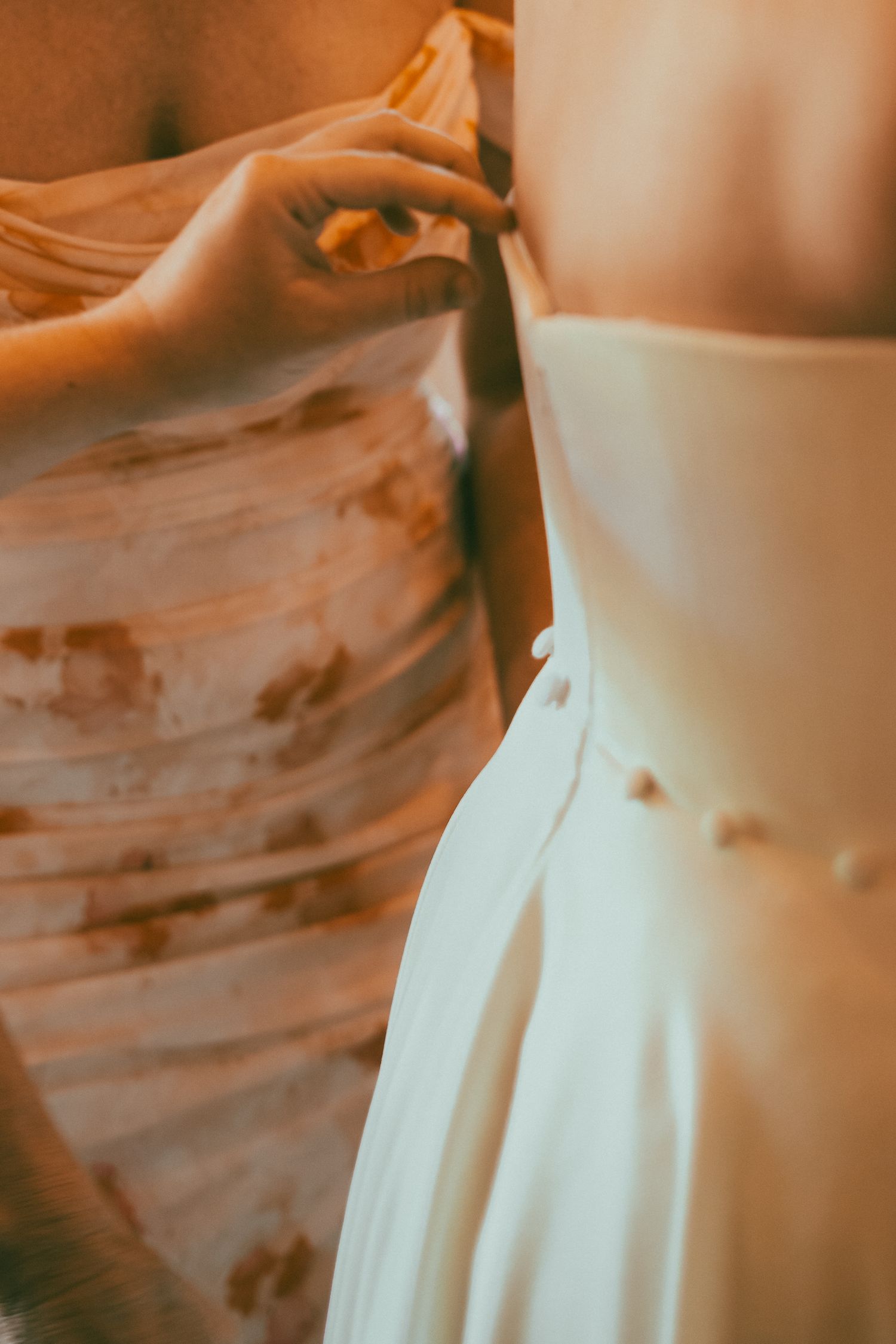 a brides dress is pulled on