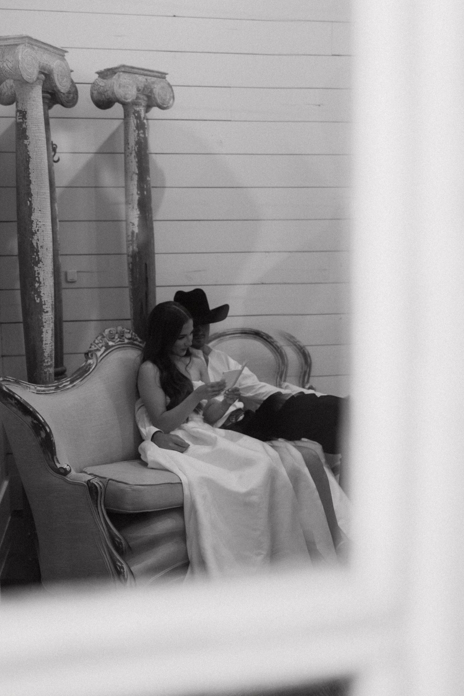 A series of black and white photos showing someone resting on a daybed or couch against a white wall.