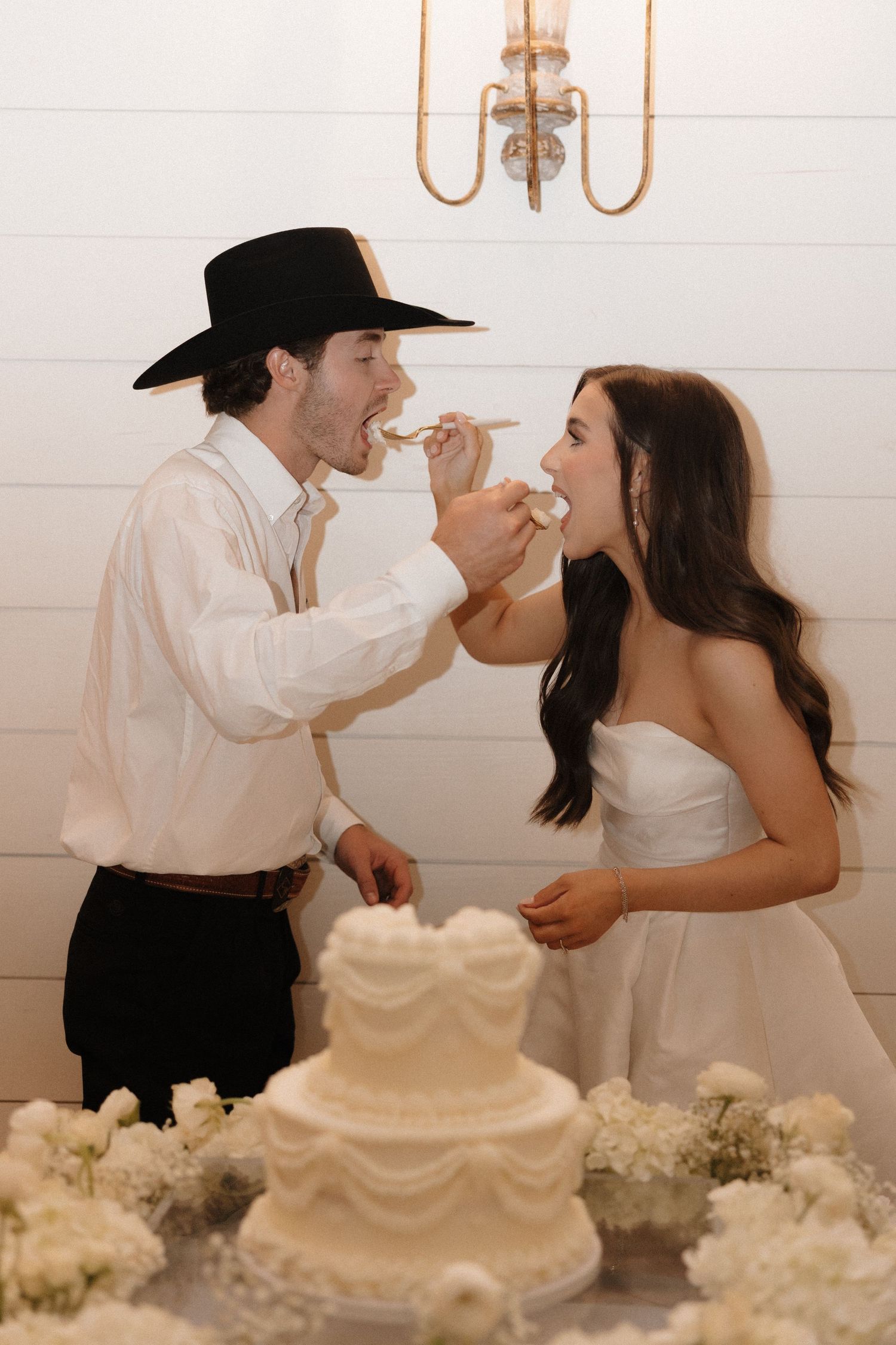 Newlywed couple playfully feeds each other wedding cake in a series of four romantic photos.