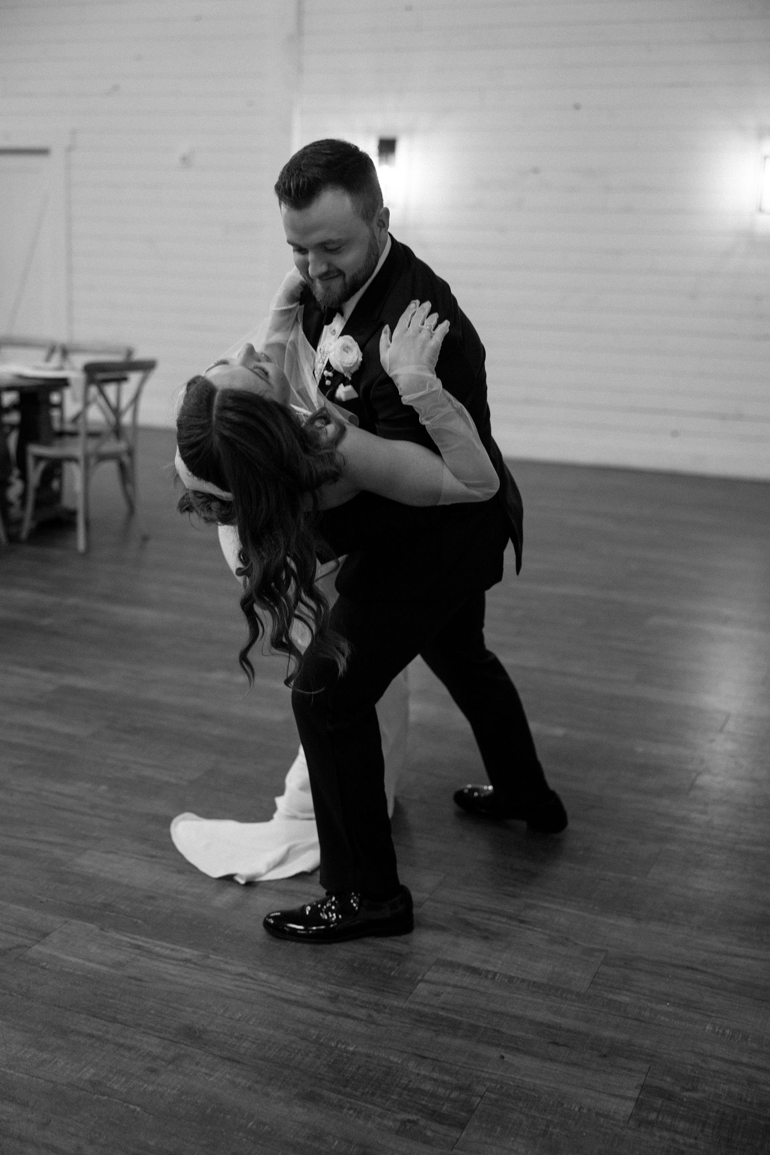 Black and white sequence of a dance performance showing graceful movements on a wooden floor in a studio space.