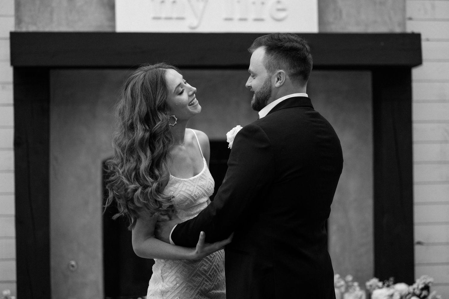 A black and white photo montage of a couple dancing together in formal attire at a wedding reception.