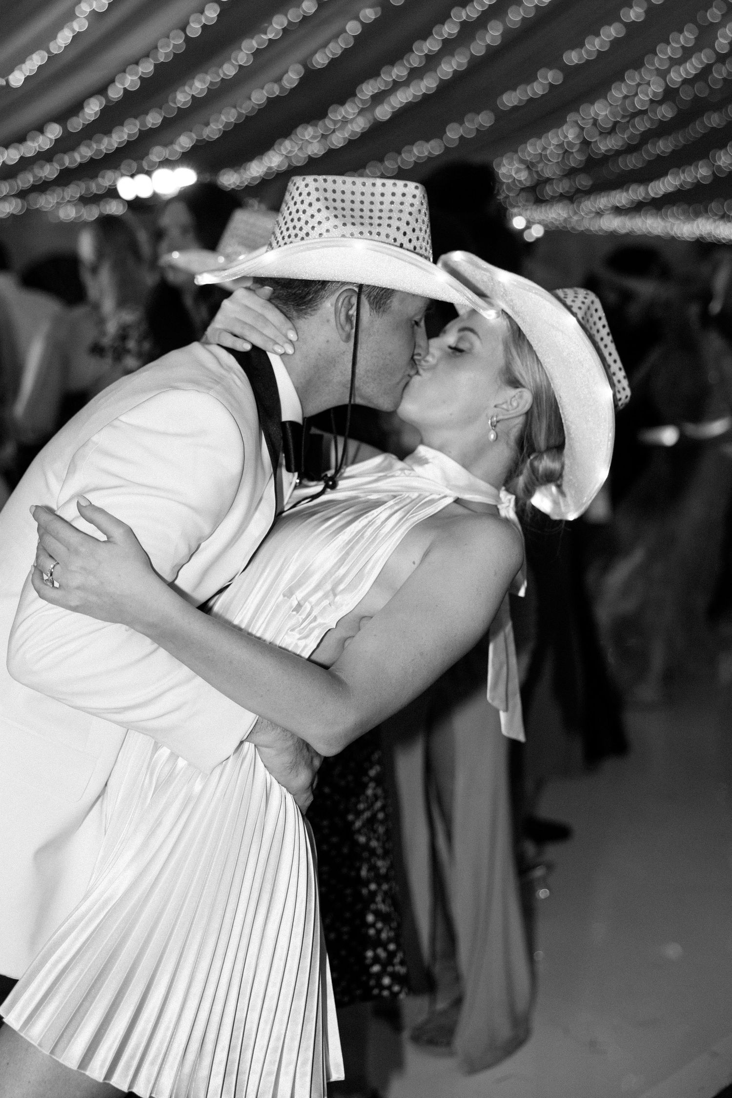 Black and white photos of couples dancing in formal attire at a wedding reception.