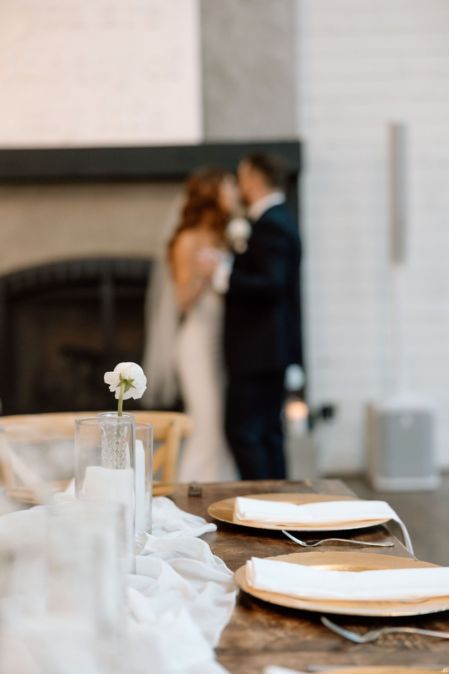 Elegant table settings with crisp white napkins and plates in a modern restaurant interior.