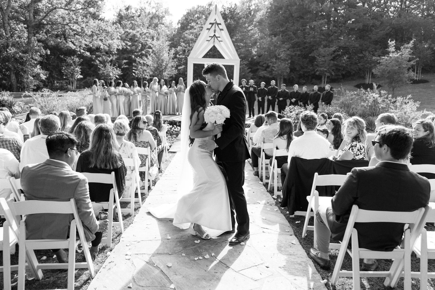 A black and white photo collage showing multiple outdoor wedding ceremony scenes with chairs set up in garden settings.