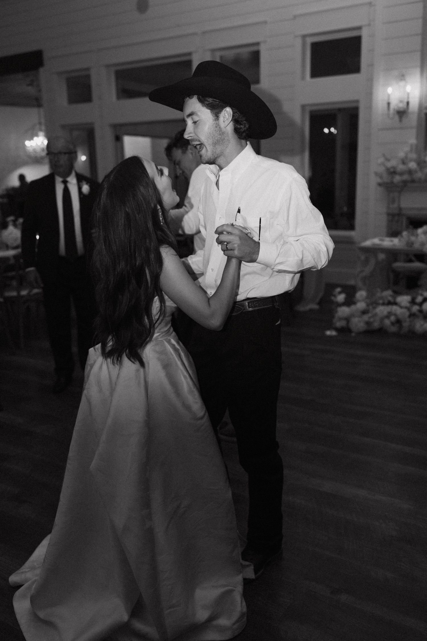 A couple dances together in a ballroom setting shown in a series of black and white photographs.