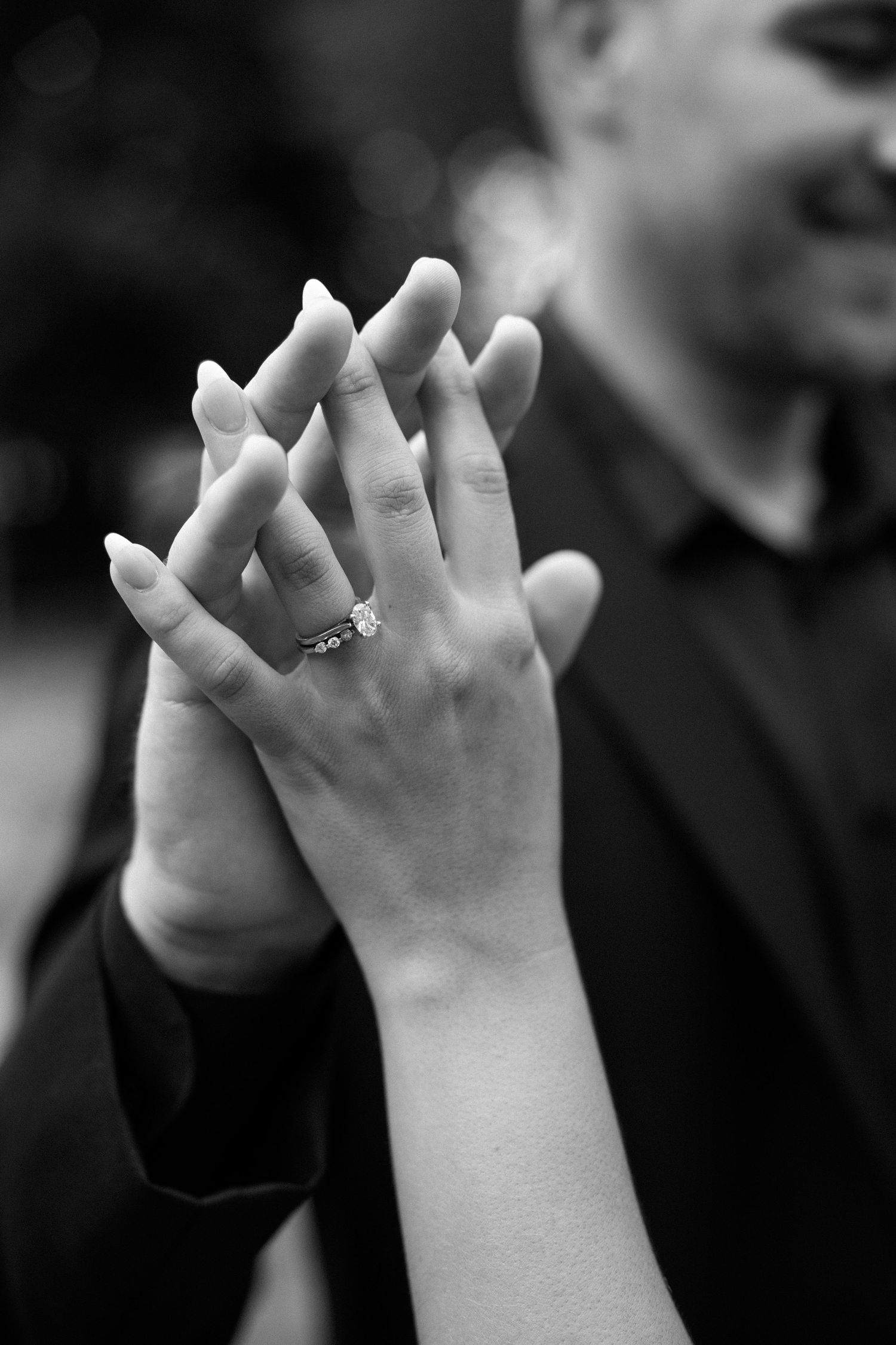 Black and white close-up photo of small hands clapping together in sequence showing rhythmic movement.