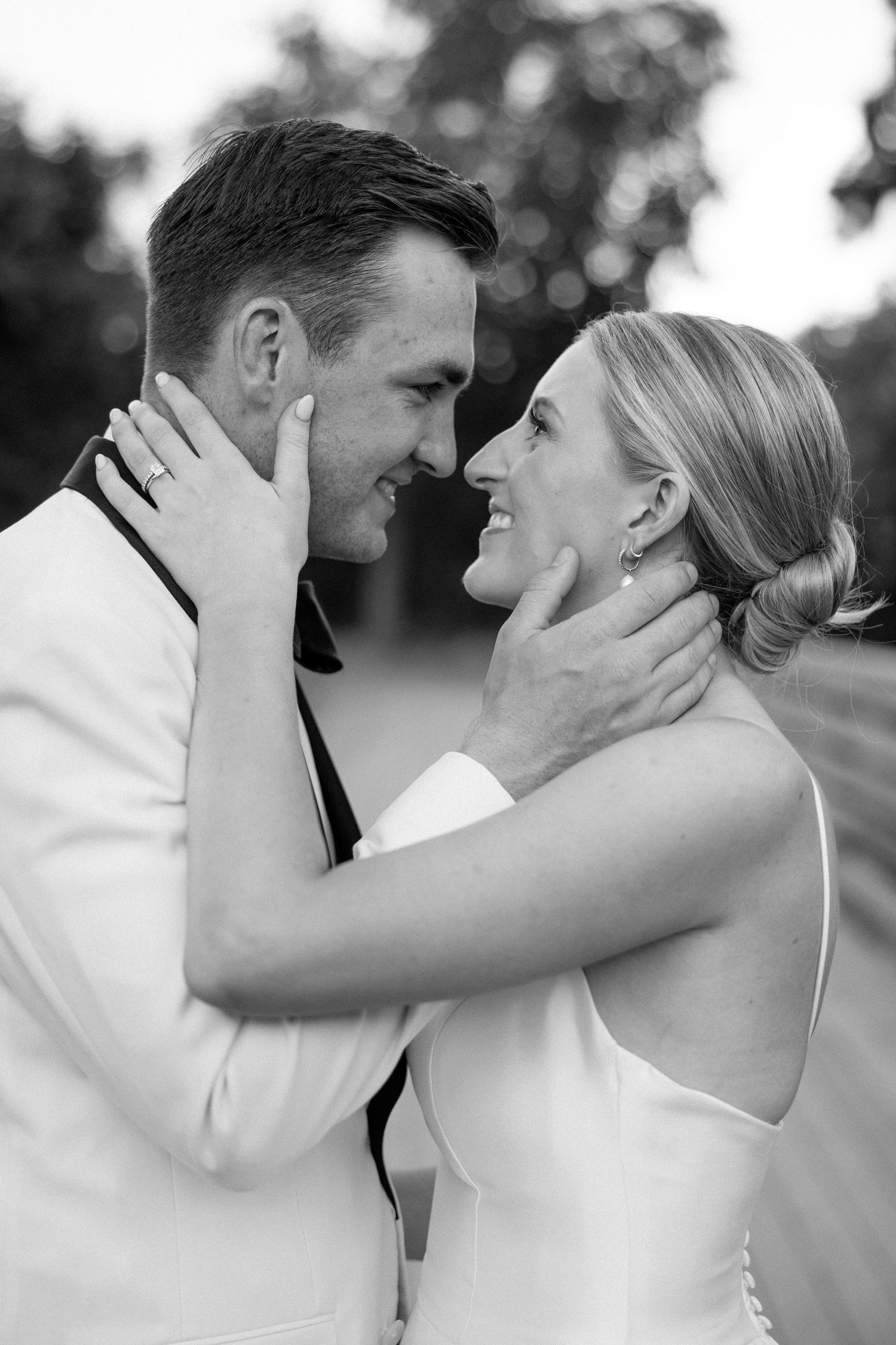 A romantic black and white photo sequence captures a tender kiss between a couple in wedding attire.