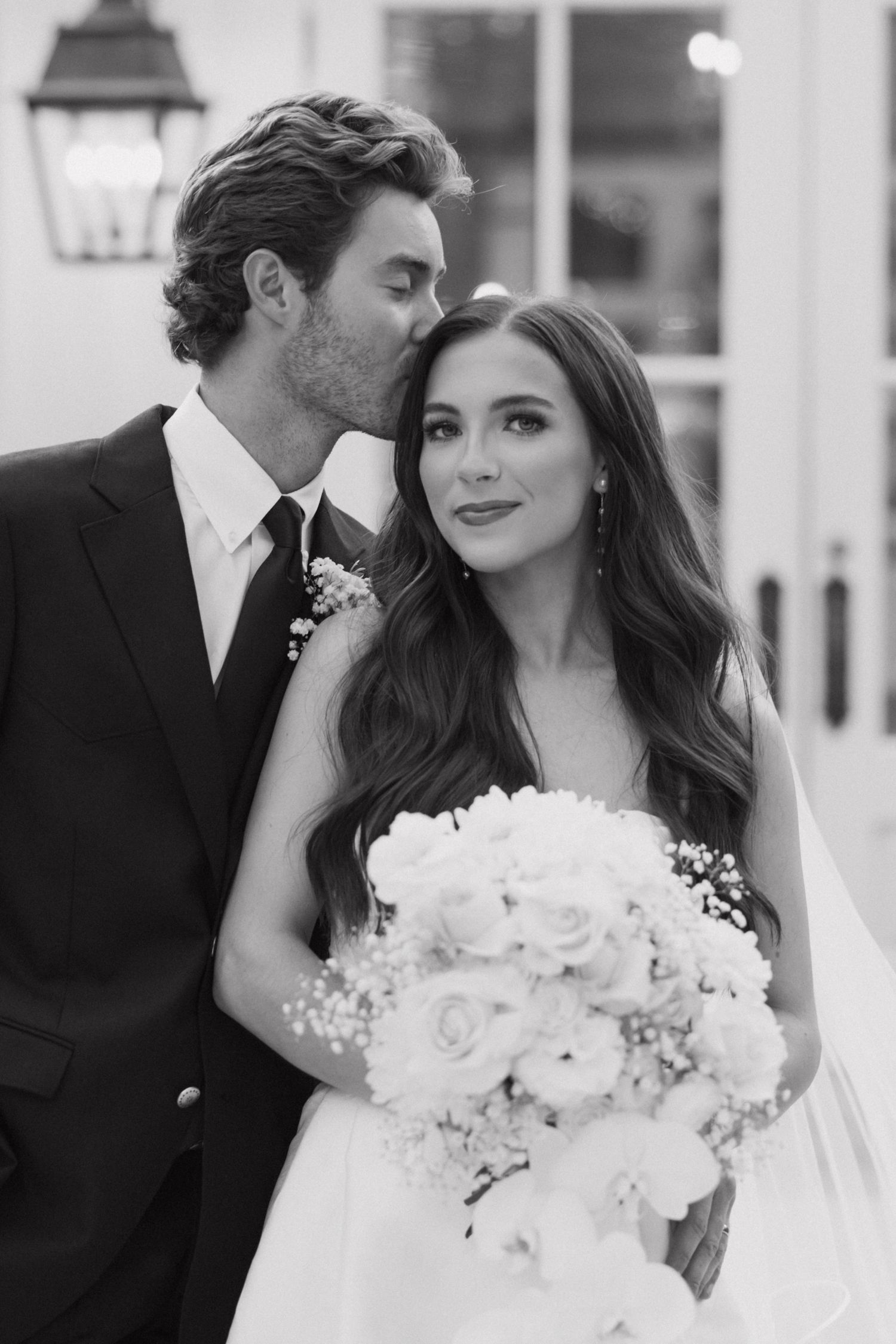 A romantic black and white wedding photo sequence showing tender moments between a couple with a white floral bouquet.