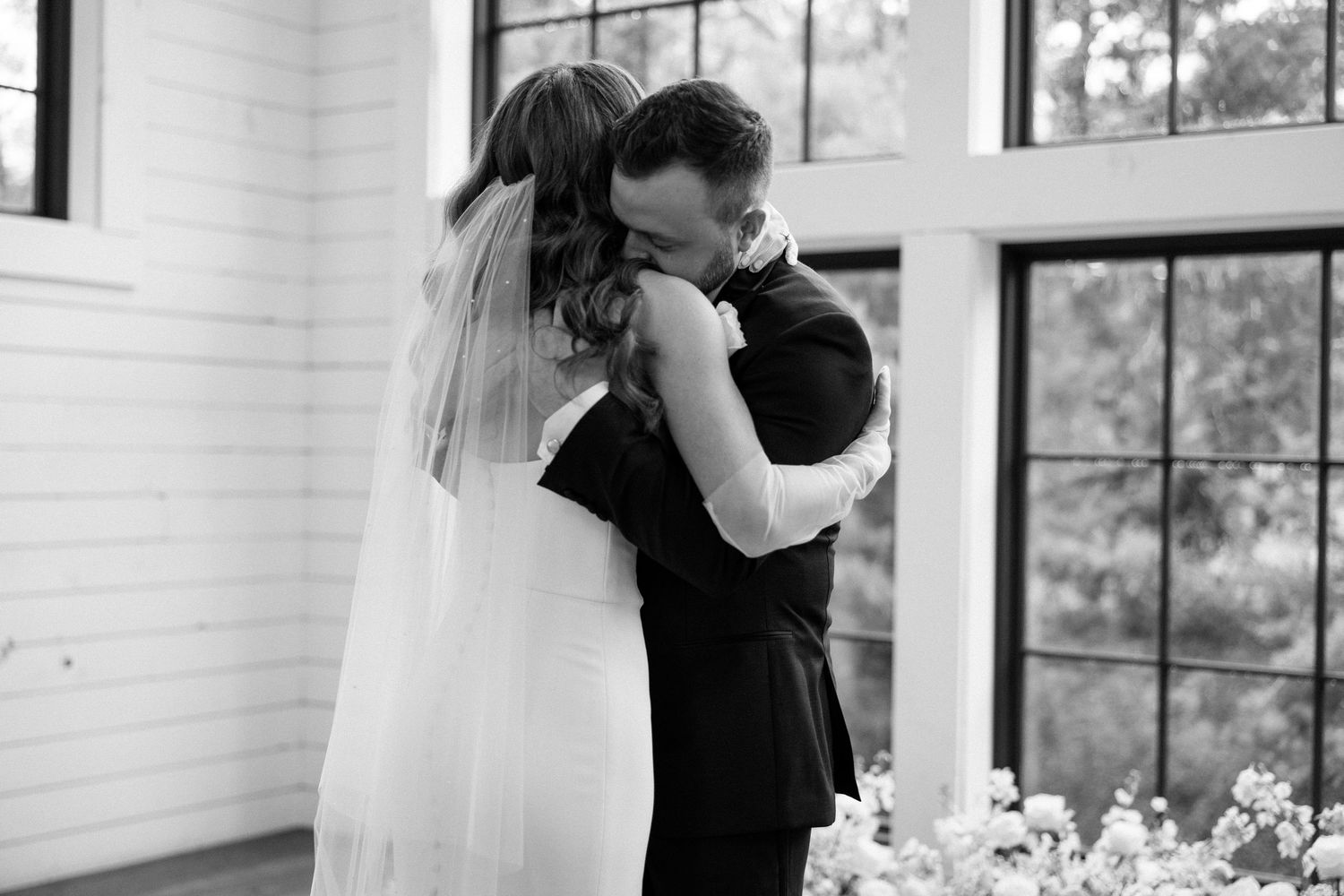 A black and white wedding photo collage showing intimate moments between a couple dancing and embracing.