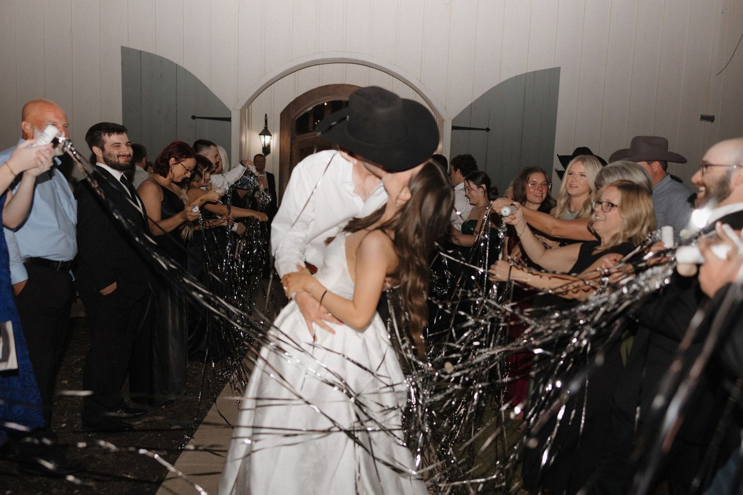 A series of wedding reception photos showing dancing, celebration, and sparklers in a dark venue.