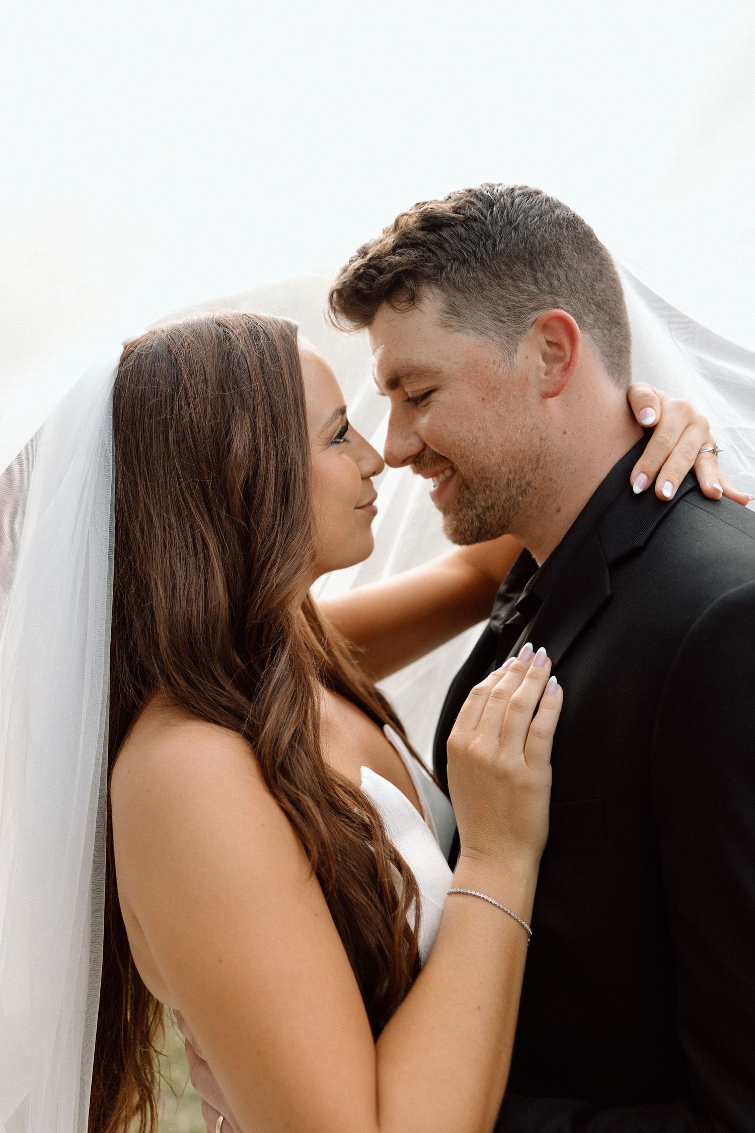 A romantic wedding couple shares an intimate moment in a series of four connected photos.