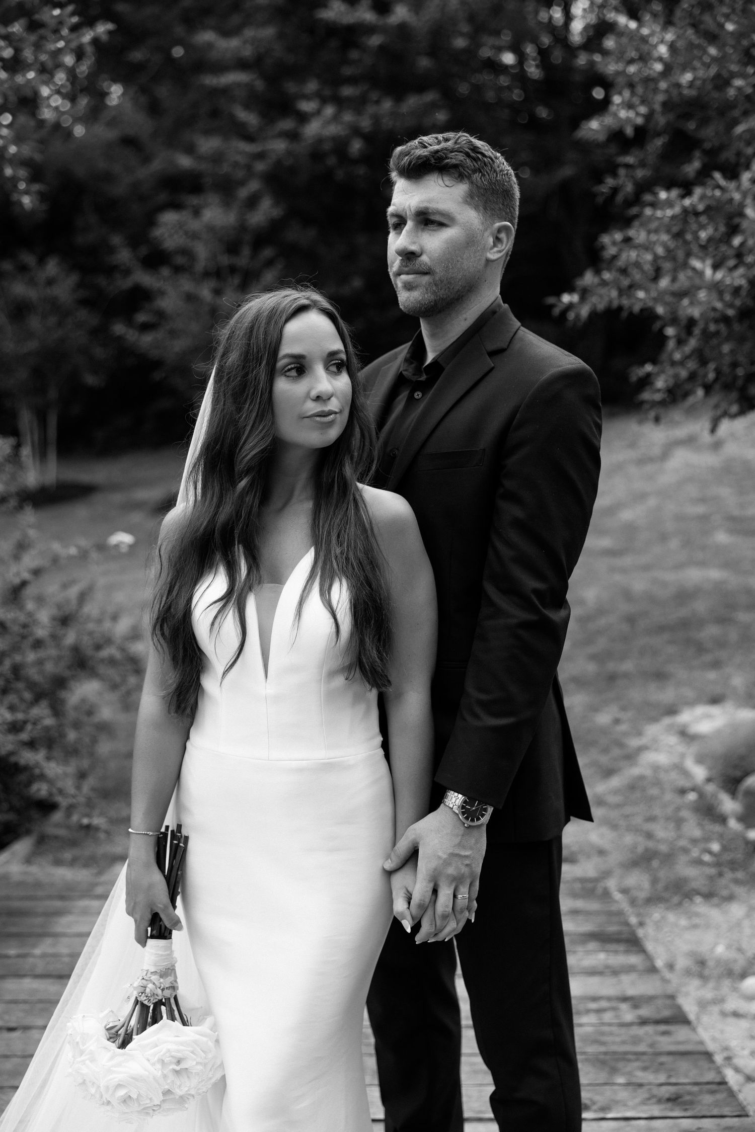 A romantic black and white wedding photo sequence showing a couple in formal attire posing together outdoors.