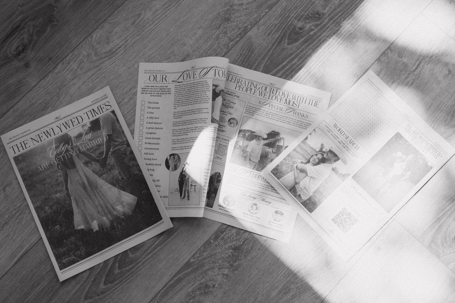 A collection of vintage newspapers and documents spread out on a surface in black and white.