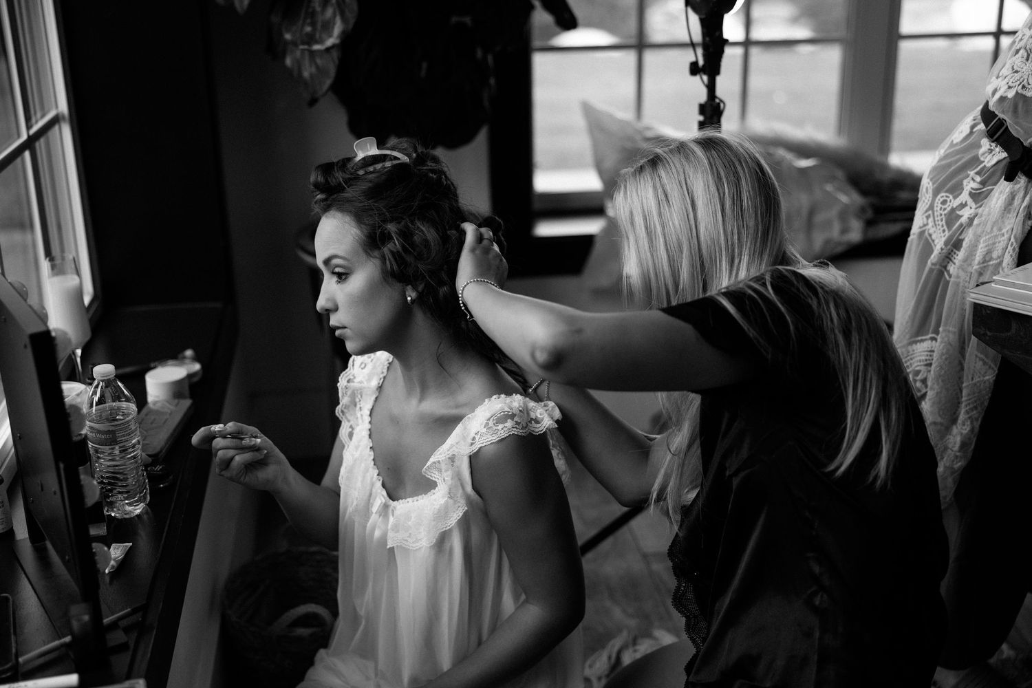 Black and white photo series showing candid moments of dancers during a ballet performance rehearsal.