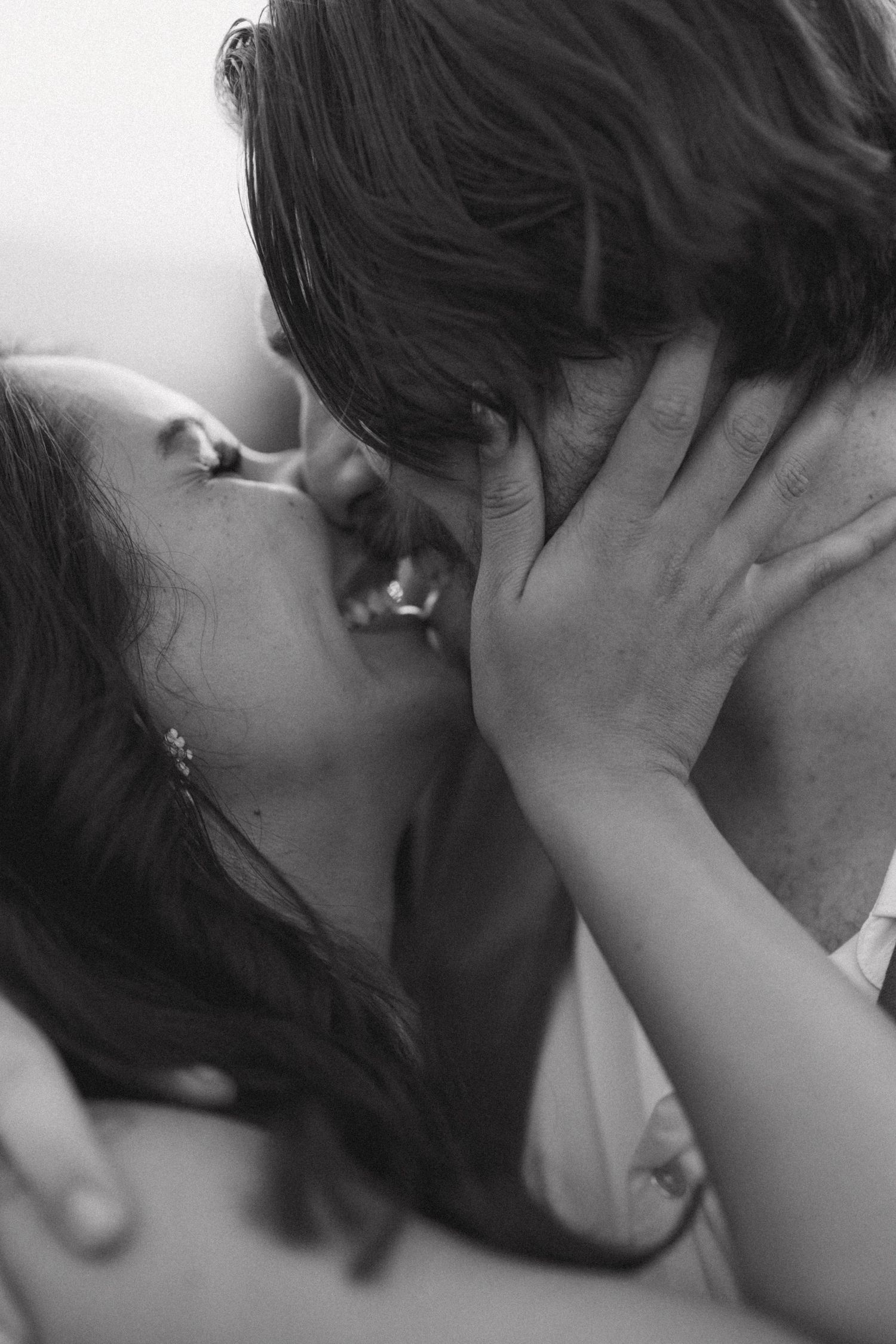 Intimate black and white romantic moment captured in soft focus.