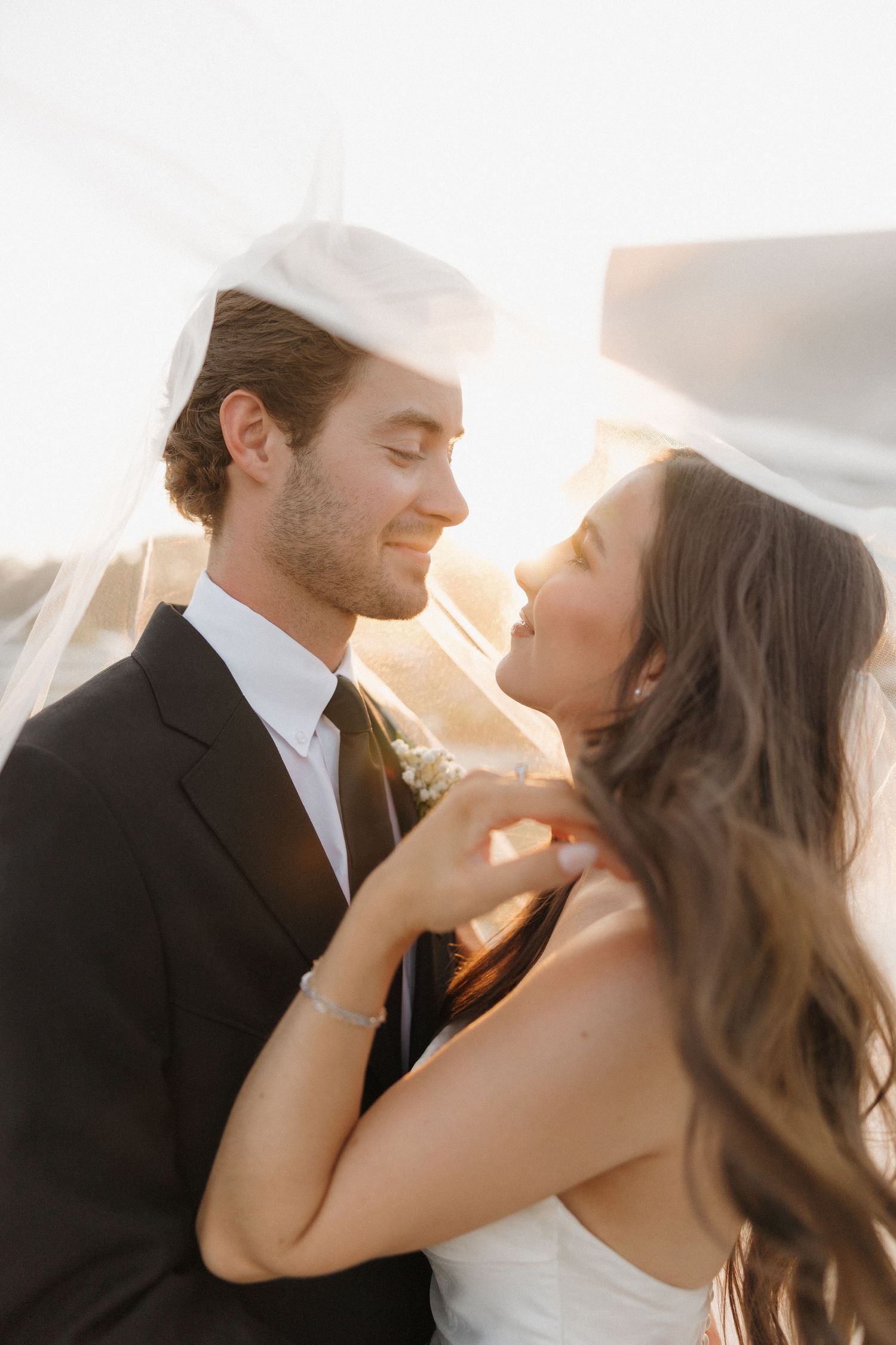A romantic couple in wedding attire shares intimate moments at sunset in a series of candid photos.
