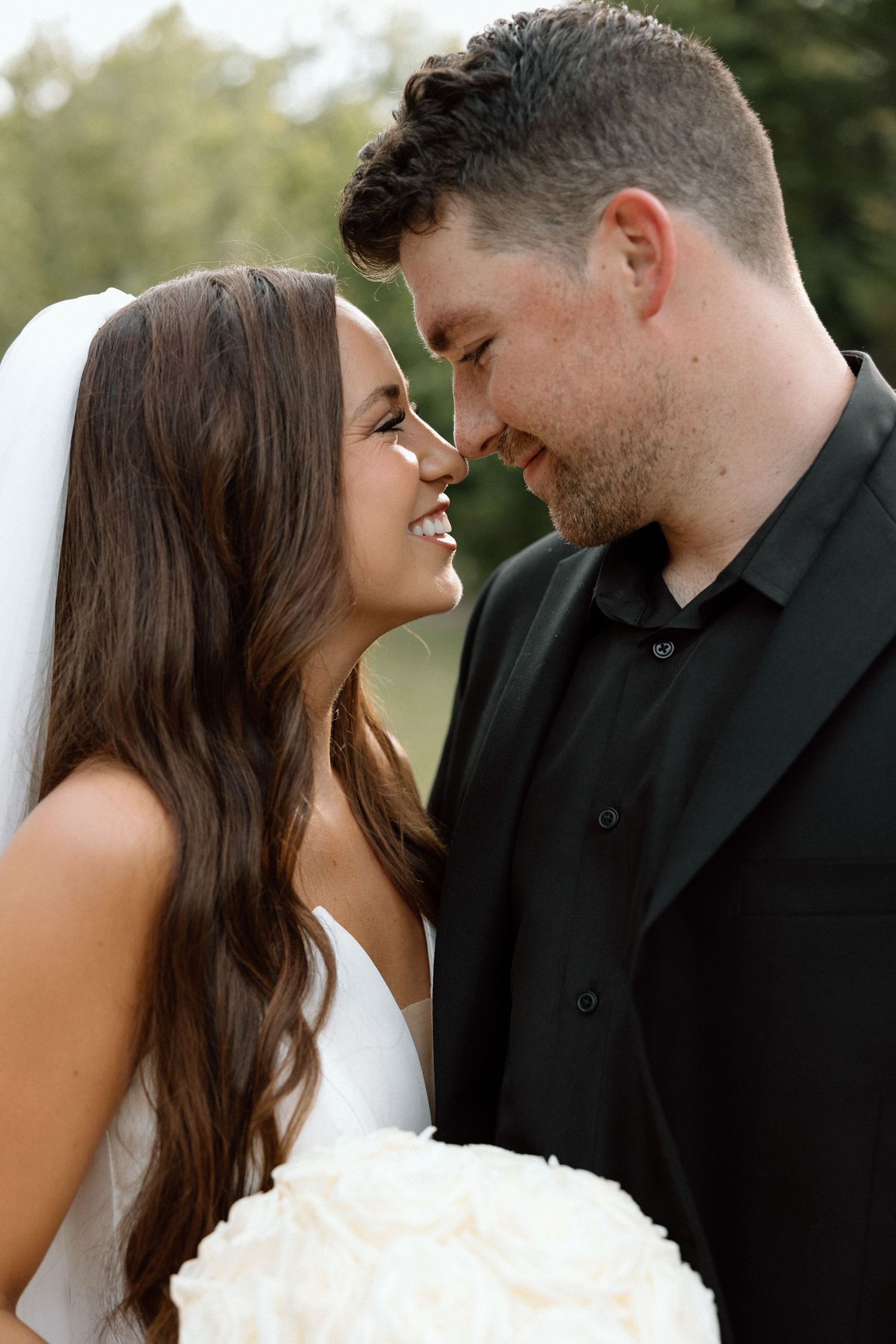 A romantic sequence of wedding photos showing a couple in black and white attire sharing intimate moments together.