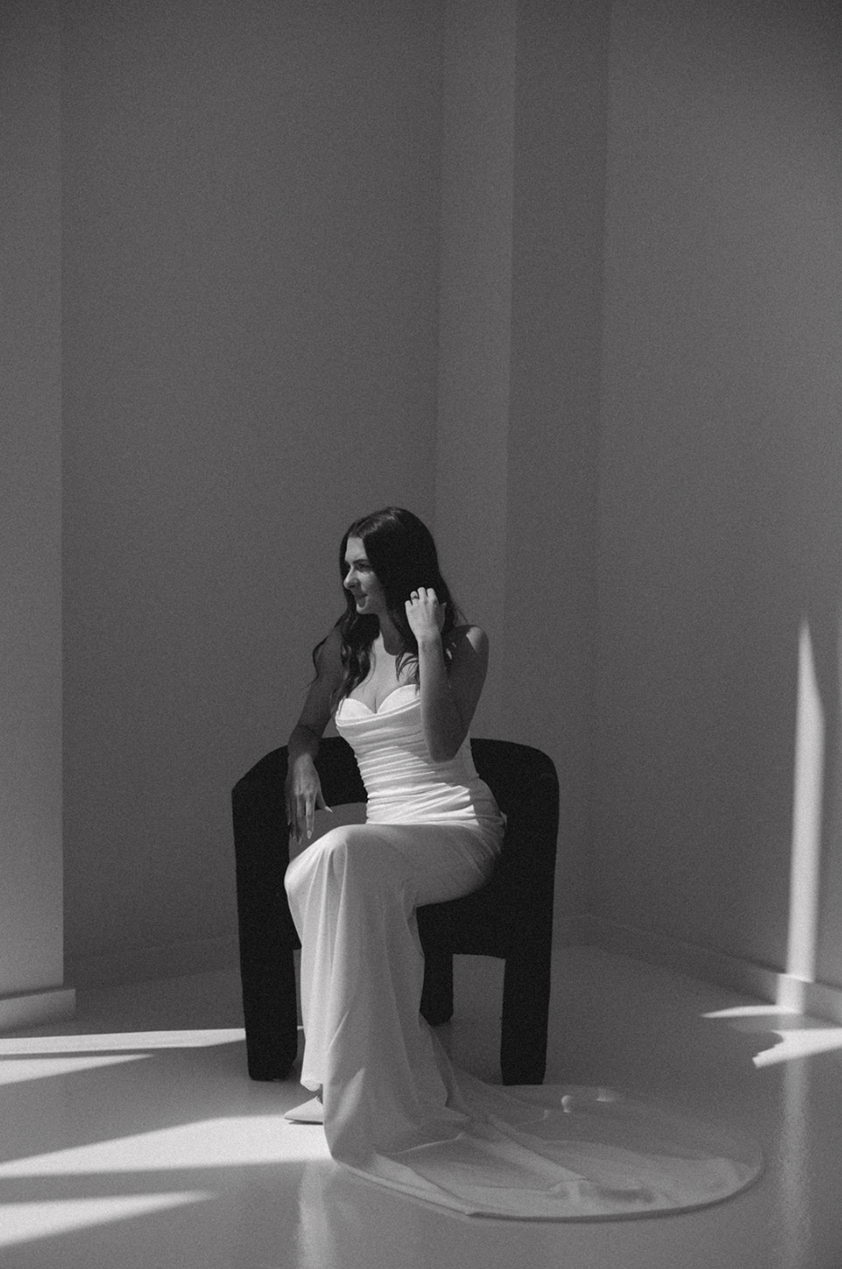 Artistic black and white photo series showing movement and shadows in minimalist white space.