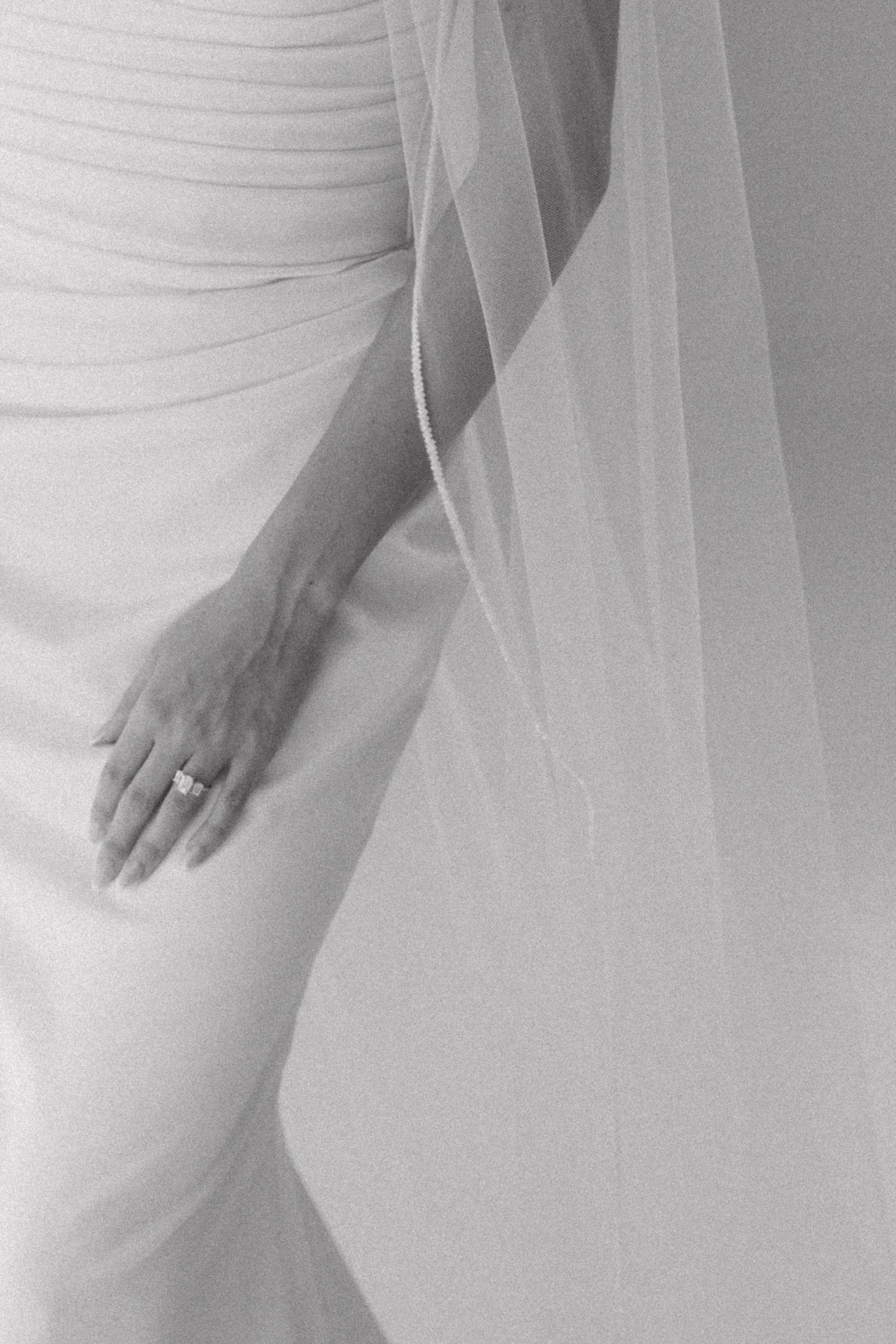 Elegant bridal detail shots focusing on flowing white dress and veil textures.