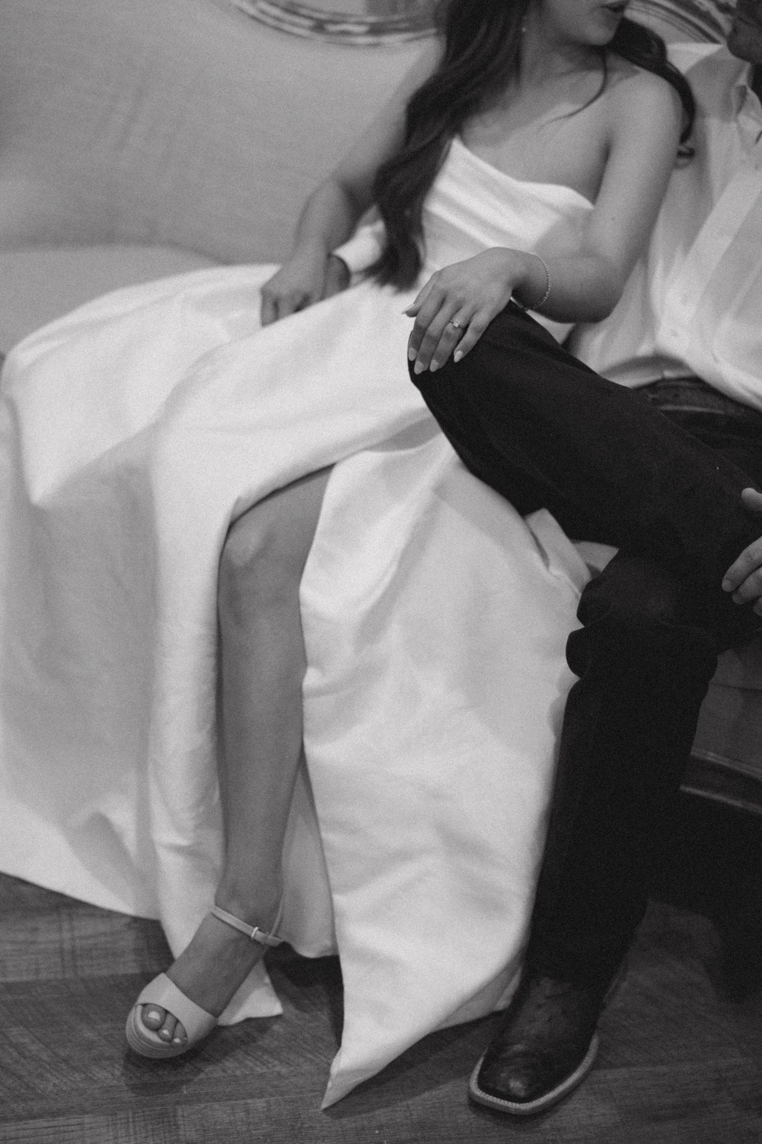 A series of five black and white photos showing feet in sandals against white fabric and dark flooring.
