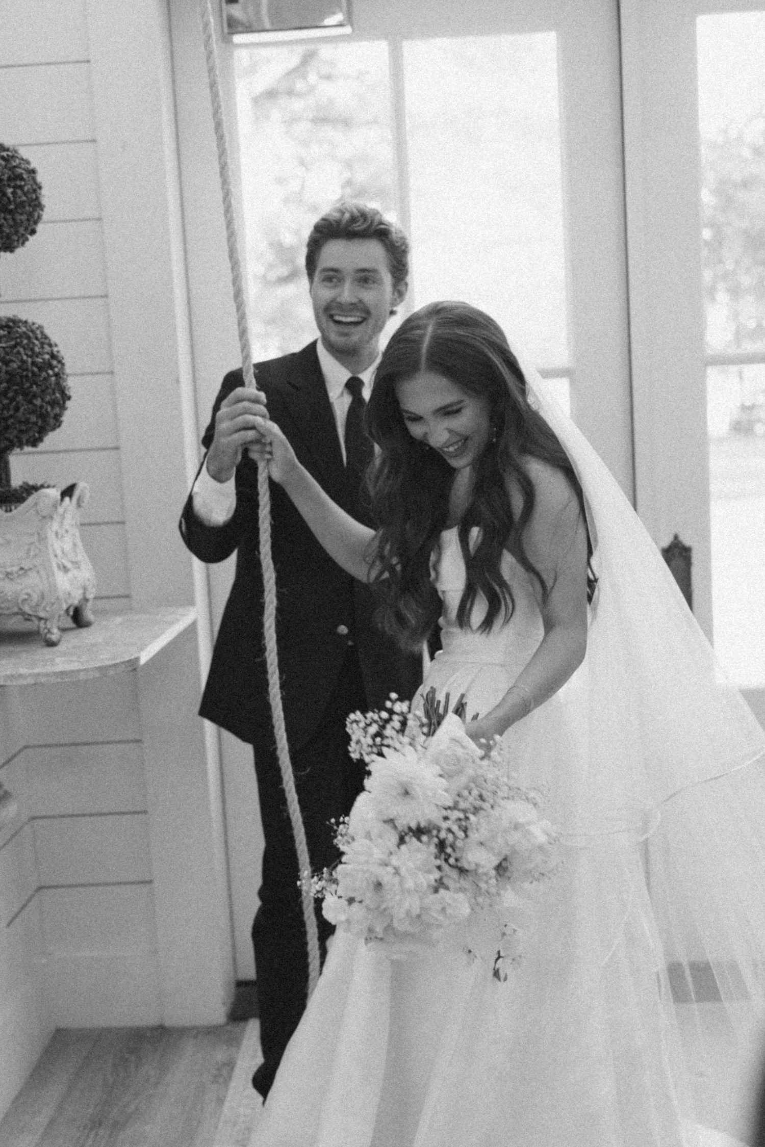 Black and white photo series of joyful newlyweds laughing together during candid wedding moments.