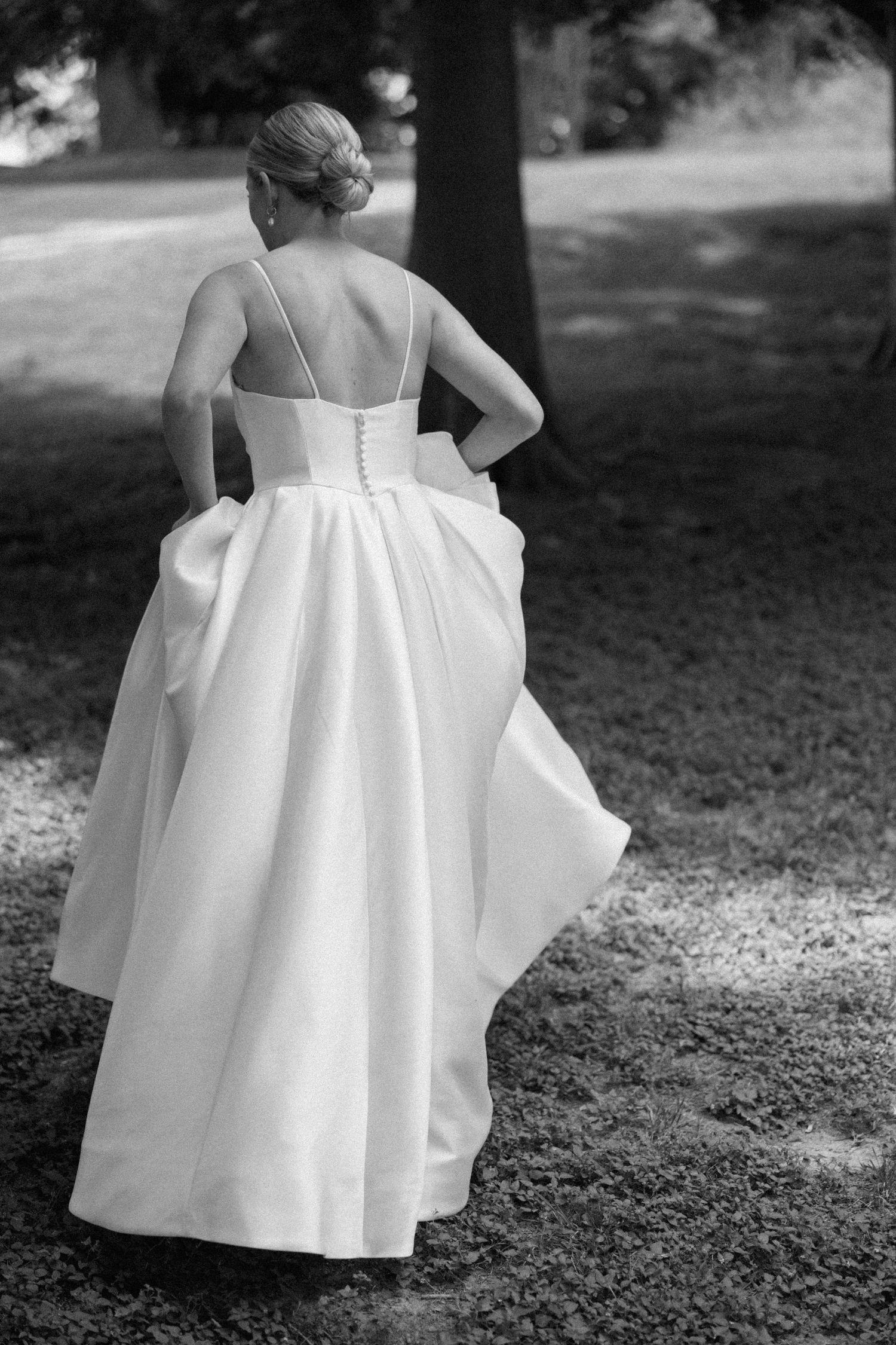 Black and white photo sequence showing a flowing white dress with ruffled details as someone twirls in a garden setting.