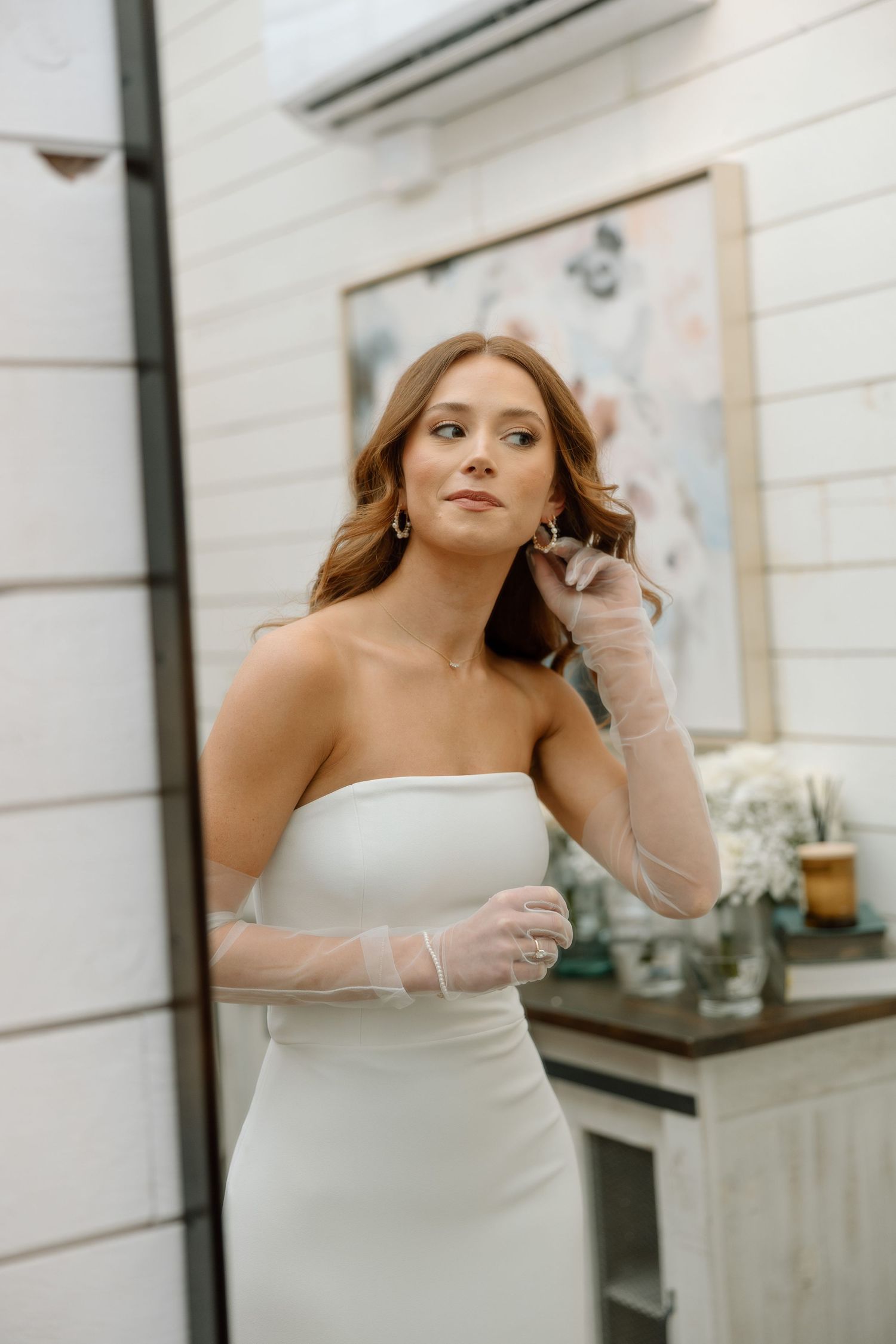 A sequence of photos showing a person in a white dress making playful expressions and gestures against a white wall.