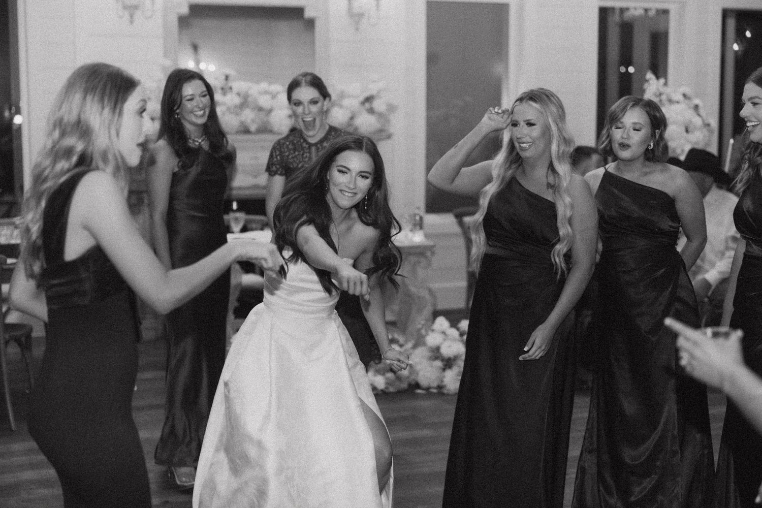 A collection of black and white wedding party photos showing guests dancing and celebrating at a reception.