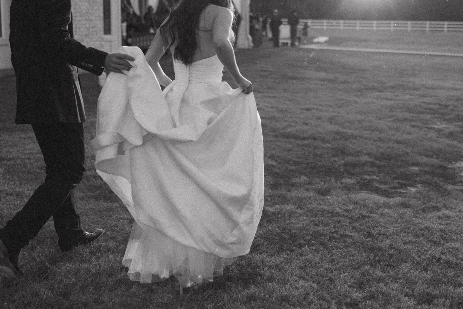 A series of black and white wedding photos showing couples dancing and embracing on a lawn.