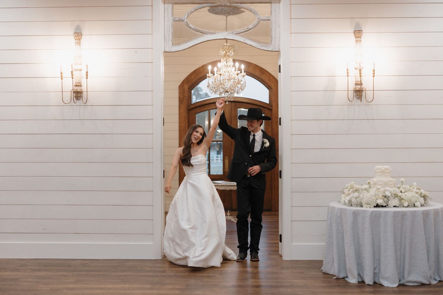 A series of elegant wedding venue photos showing white paneled walls, arched doorways, and decorative sconces.