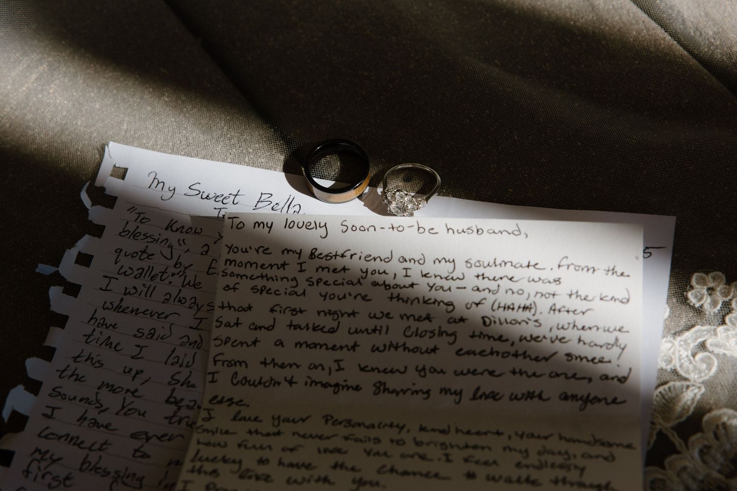 Handwritten wedding vow letter addressed My Sweet Bella with two gold rings resting on top.