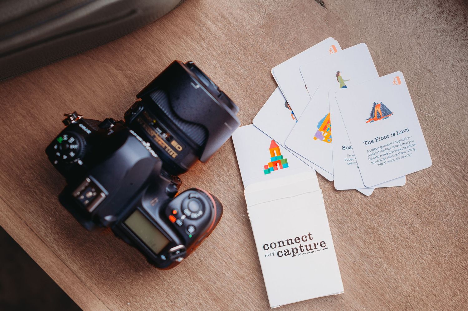 Nikon DSLR camera next to photographer prompt cards for in-hone photo sessions orlando fl.
