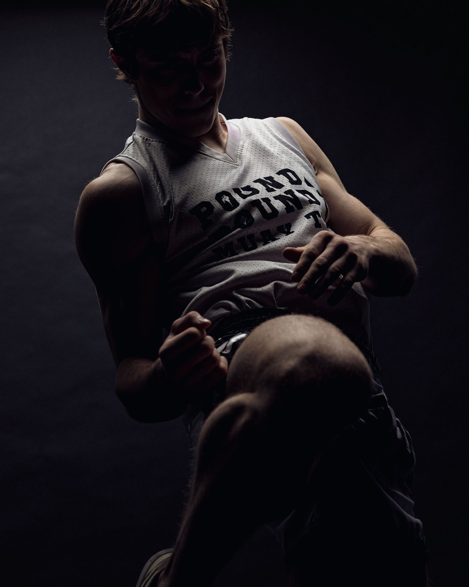 A dimly lit series of photos showing emotional embraces and intimate moments set against a dark background.
