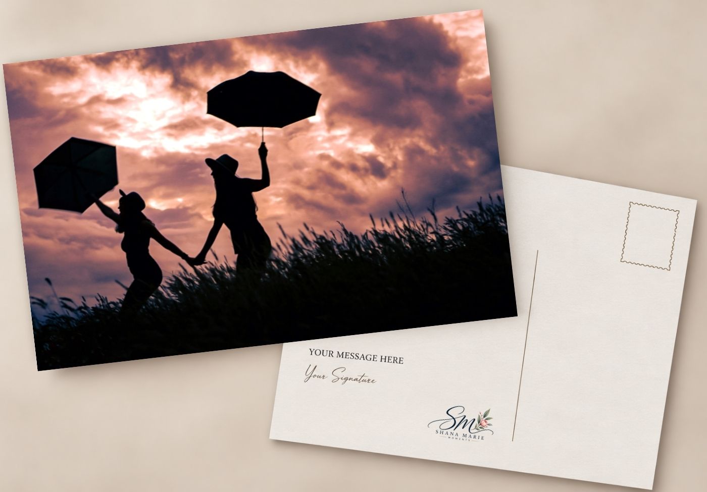 Silhouette postcard of two people holding umbrellas at sunset with dramatic clouds, featuring a customizable message area on the back.