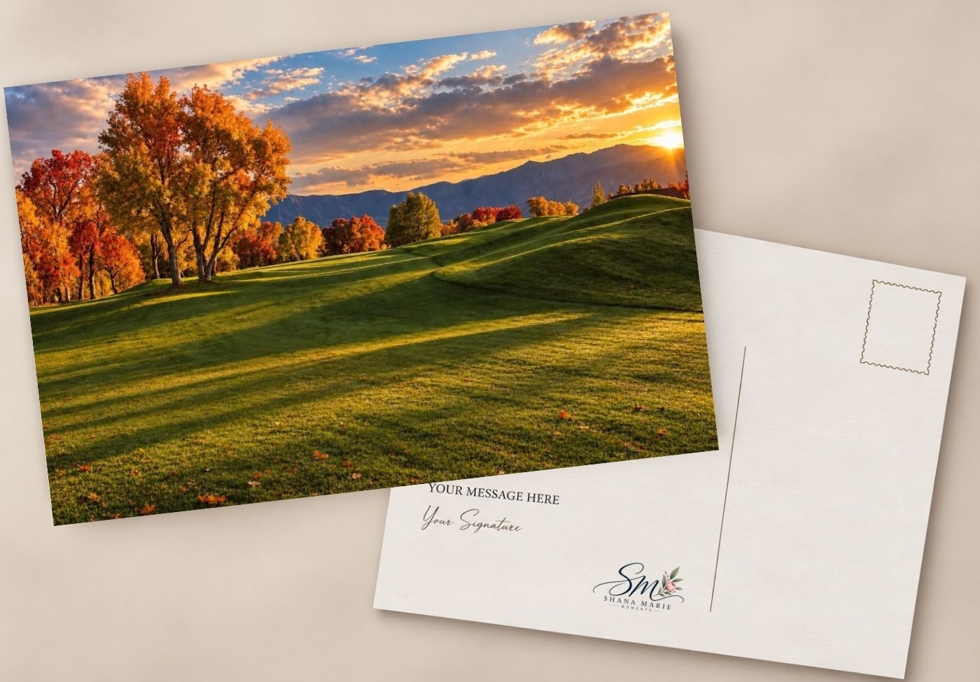 Autumn sunset postcard with vibrant fall trees, green golf course, and mountain backdrop, shown front and back.