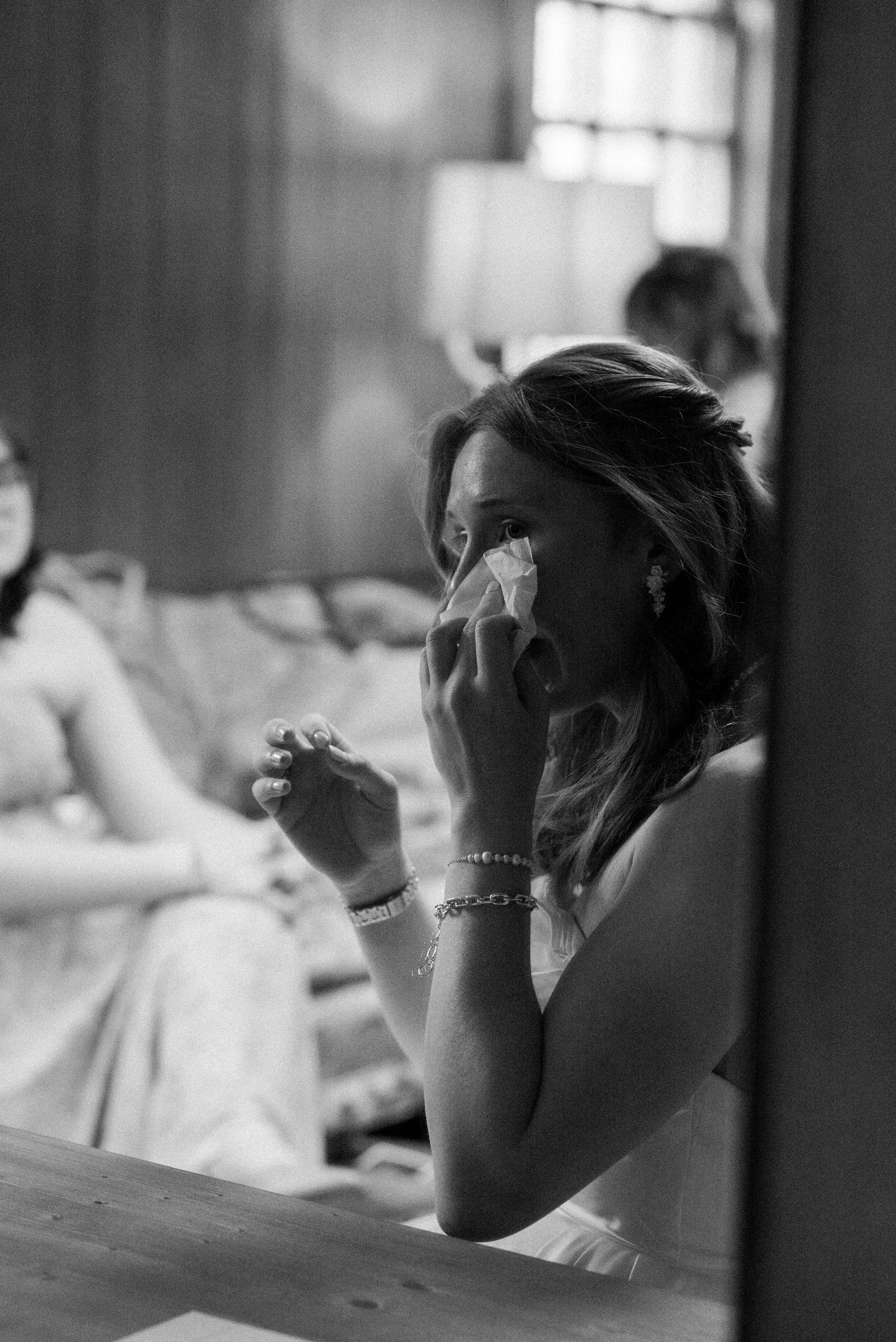 Black and white artistic shots capturing emotional moments during wedding preparations.