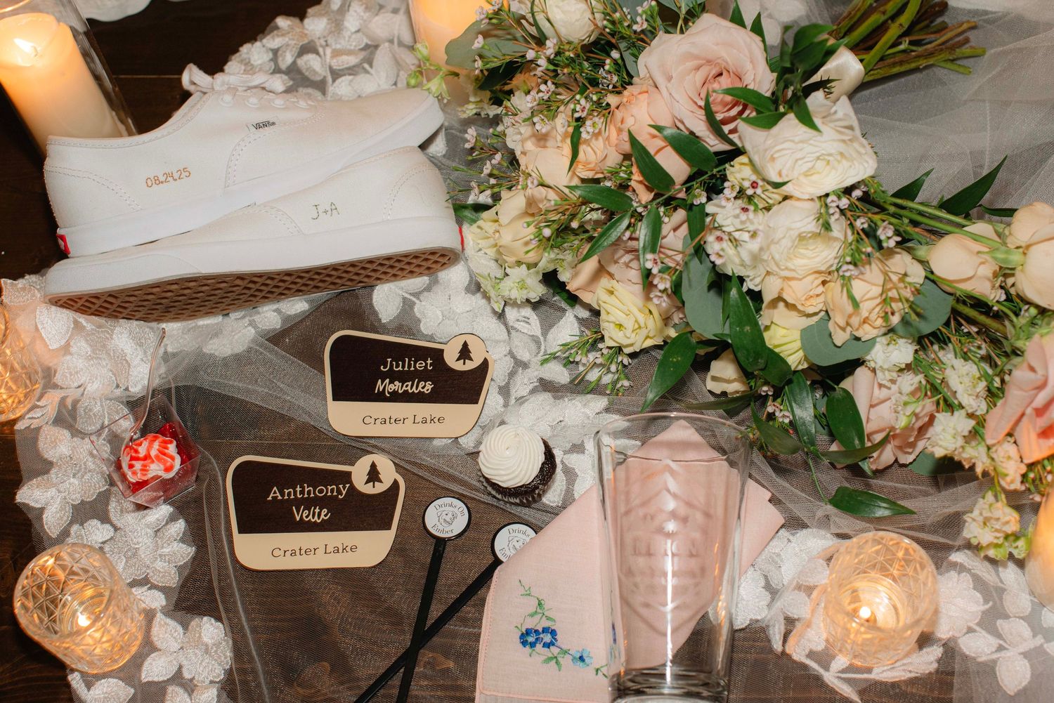 Elegant wedding reception table with floral centerpieces and candle decorations.