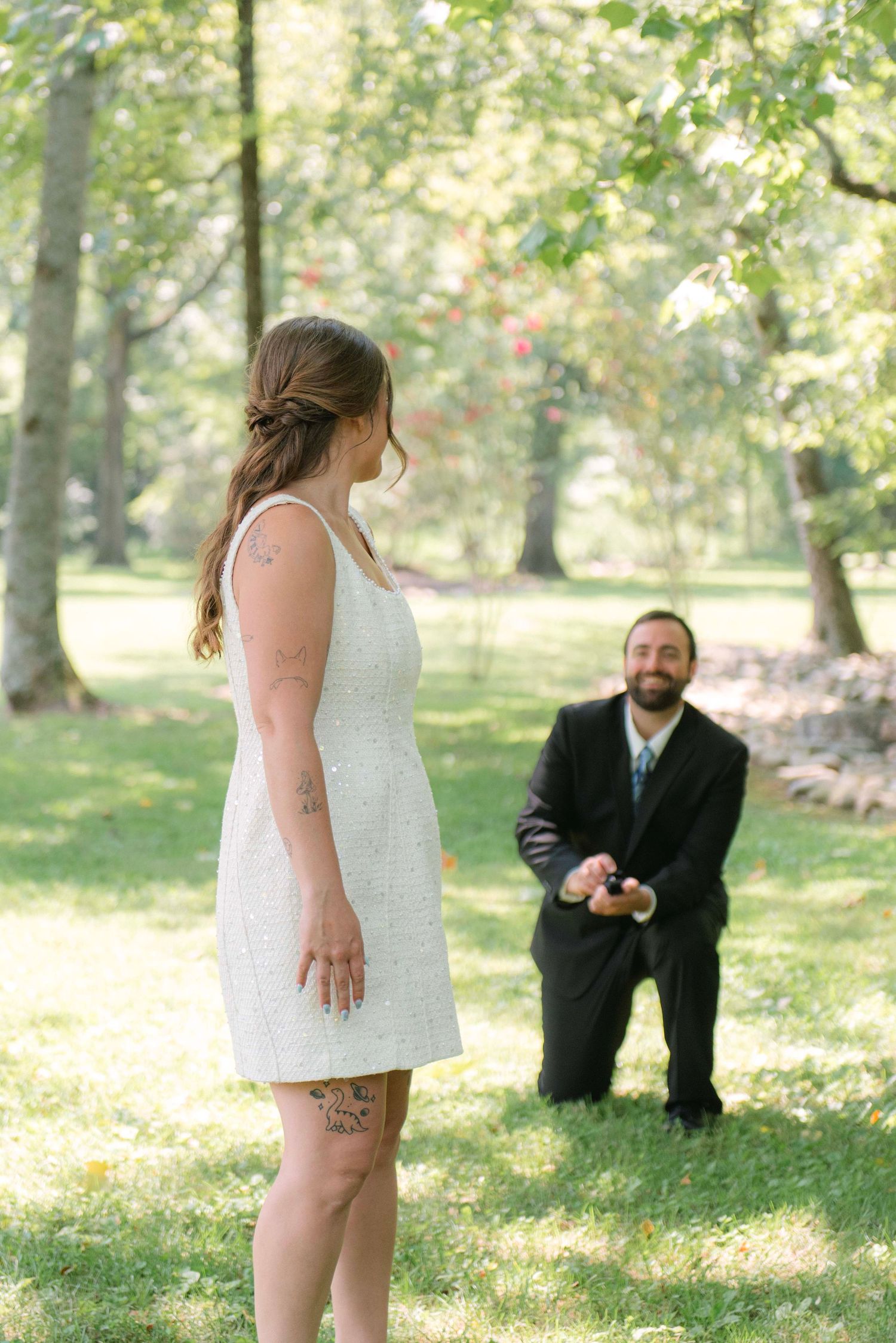 A wedding photo sequence showing a playful moment between a bride in white and groom in black outdoors in a park setting.