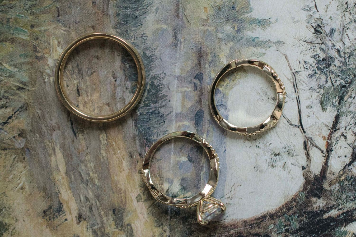 Artistic abstract wall texture with circular patterns and weathered paint in muted gray and white tones.