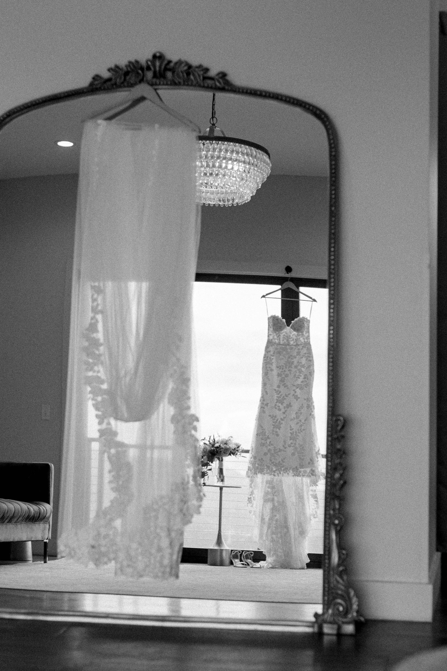Elegant crystal chandeliers hang from the ceiling in a bright modern interior space.
